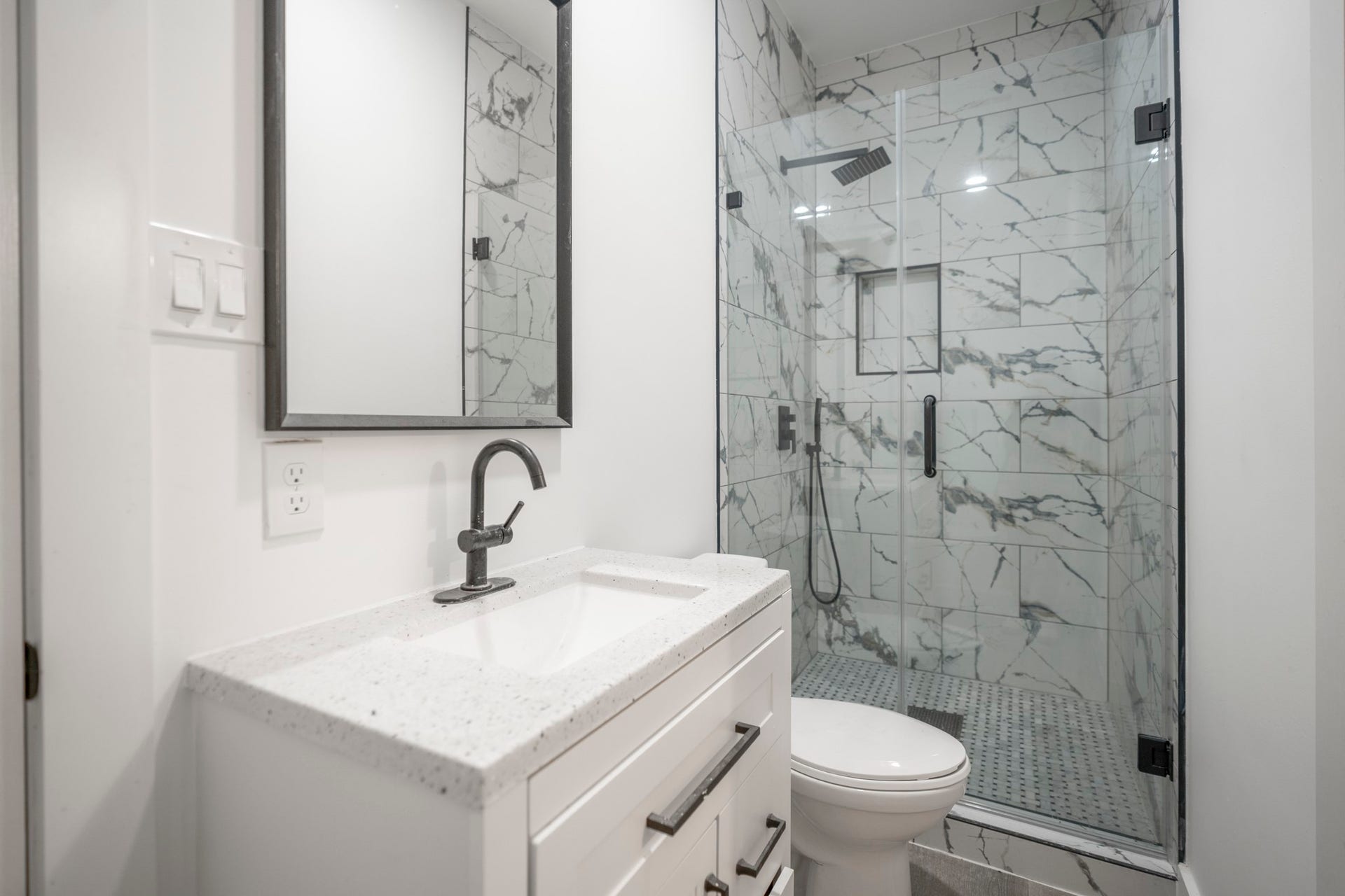 31219 Edgewater Drive, Magnolia, TX 77354 The barns bathroom includes a vanity and a glass-enclosed shower with marble finishes.