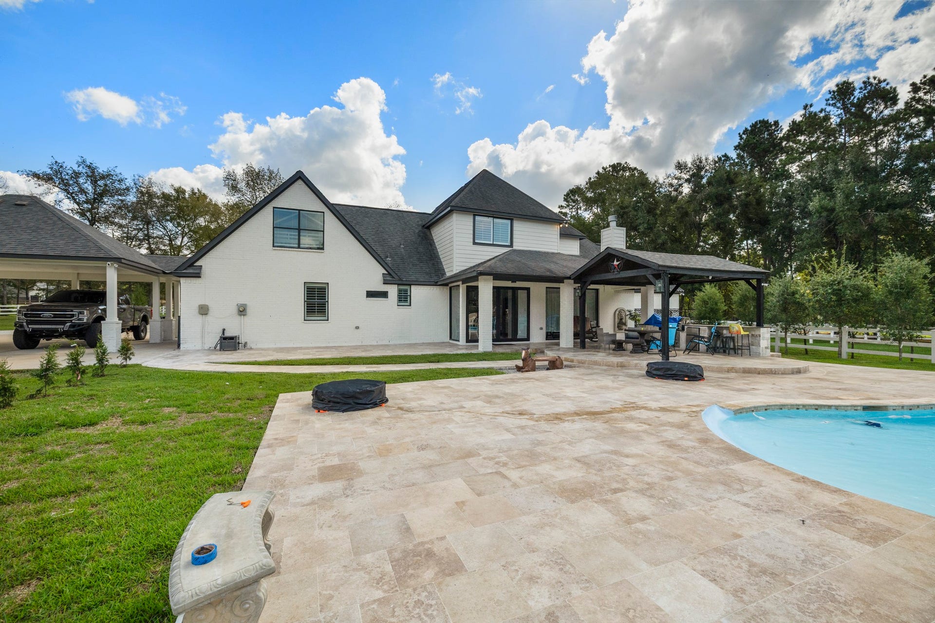31219 Edgewater Drive, Magnolia, TX 77354 From the back yard, take in the rear of the home, covered outdoor space and pool.