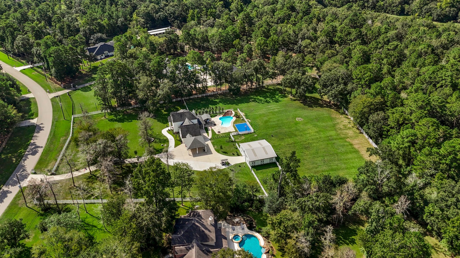 31219 Edgewater Drive, Magnolia, TX 77354 This angle shows the expanse of lawn and the wooded edge of the property.