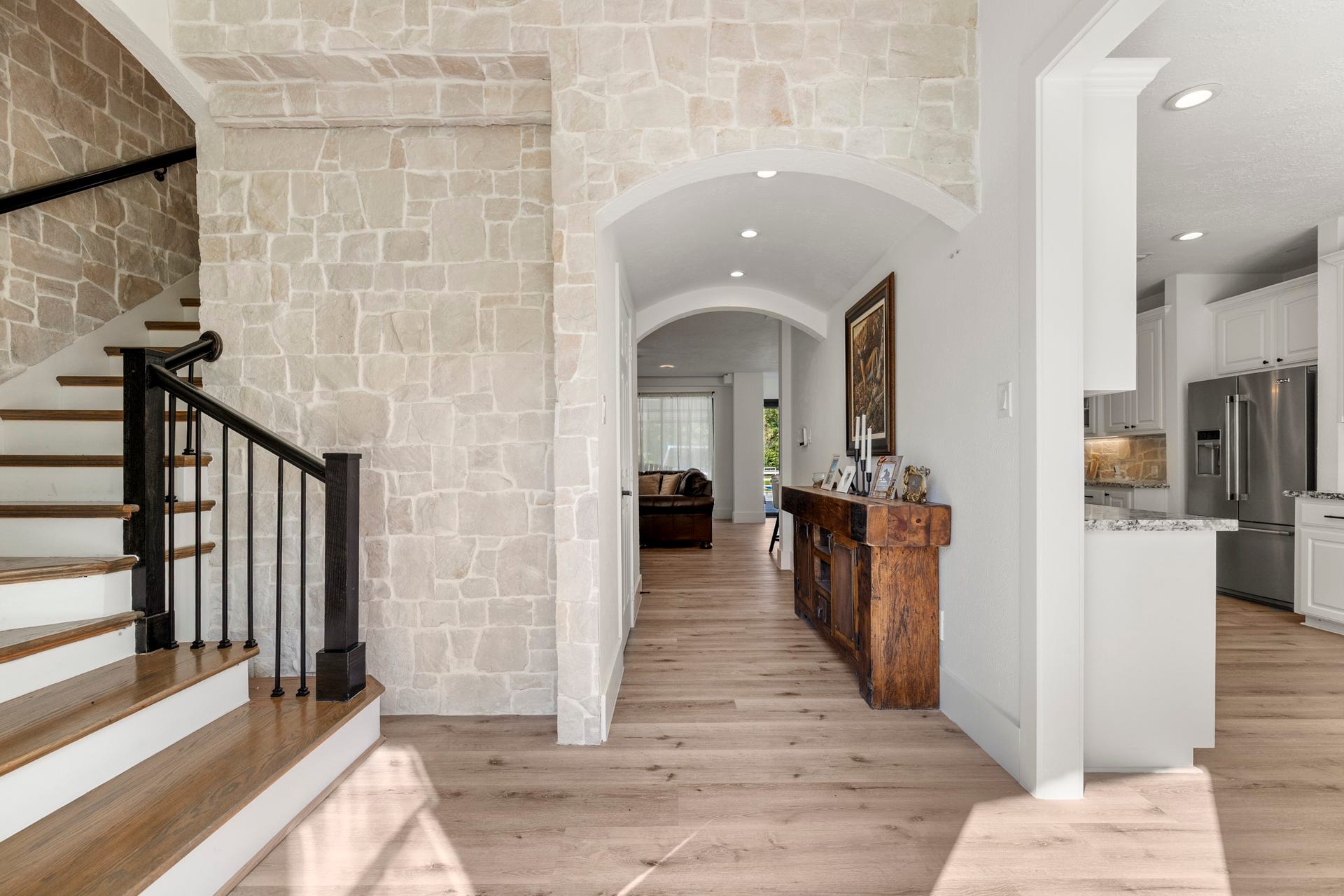 31219 Edgewater Drive, Magnolia, TX 77354 Inside, stone accents, an arched opening and wood-look flooring welcome you into the entry.