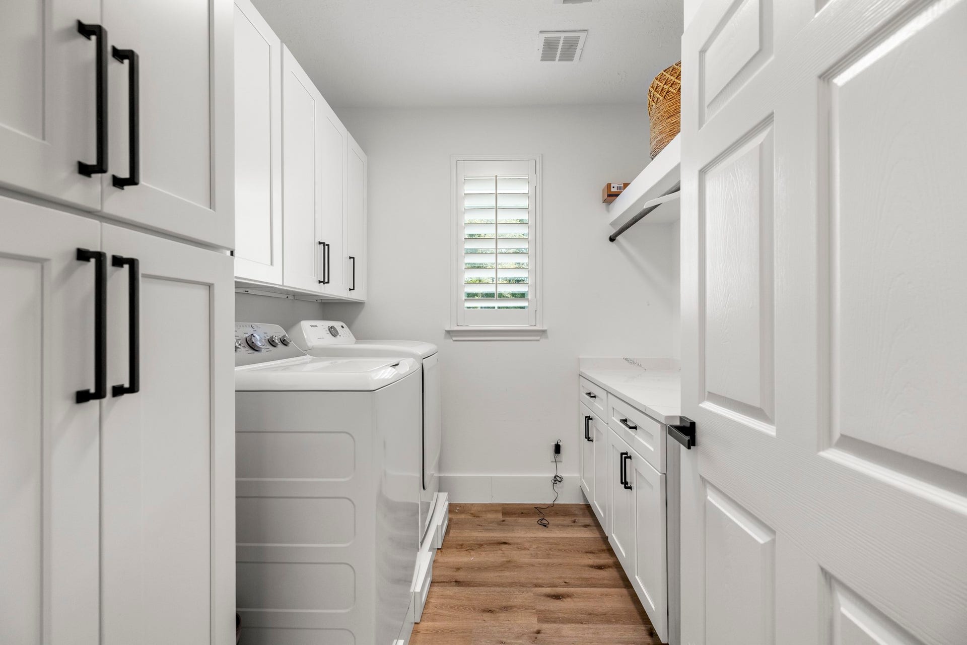 31219 Edgewater Drive, Magnolia, TX 77354 The utility room includes cabinetry, a folding counter and space for a washer and dryer.