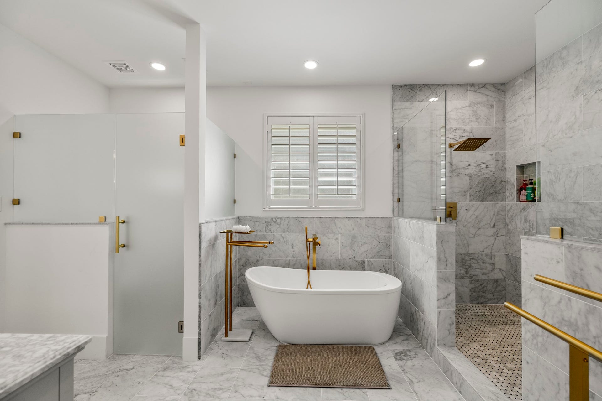 31219 Edgewater Drive, Magnolia, TX 77354 Across the bathroom, a freestanding soaking tub sits beside the glass-enclosed shower.
