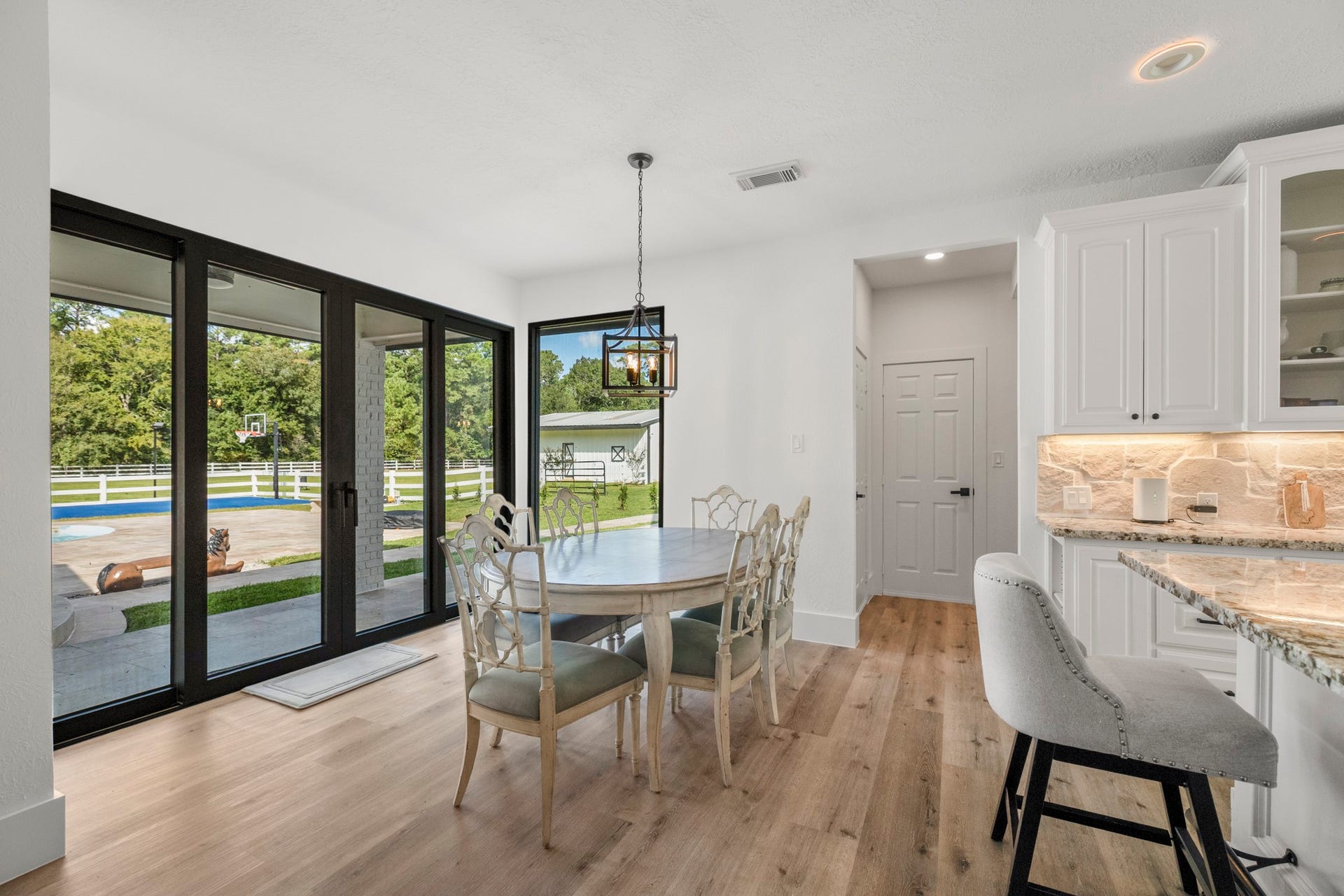 31219 Edgewater Drive, Magnolia, TX 77354 The adjoining breakfast area opens toward the outdoors through a newly installed wall of glass doors.