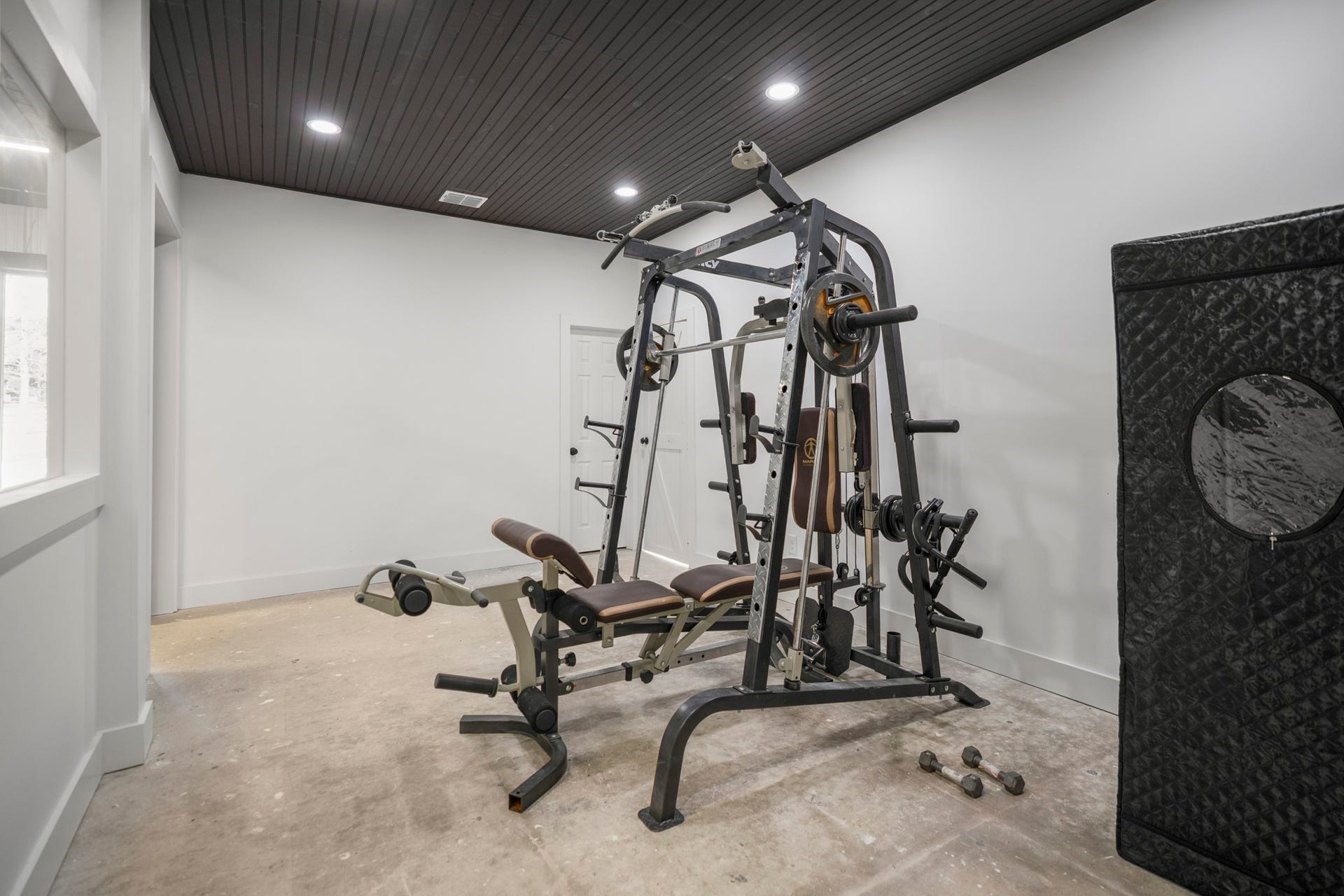 31219 Edgewater Drive, Magnolia, TX 77354 Inside the barn, a dedicated gym features recessed lighting and a contrasting ceiling.