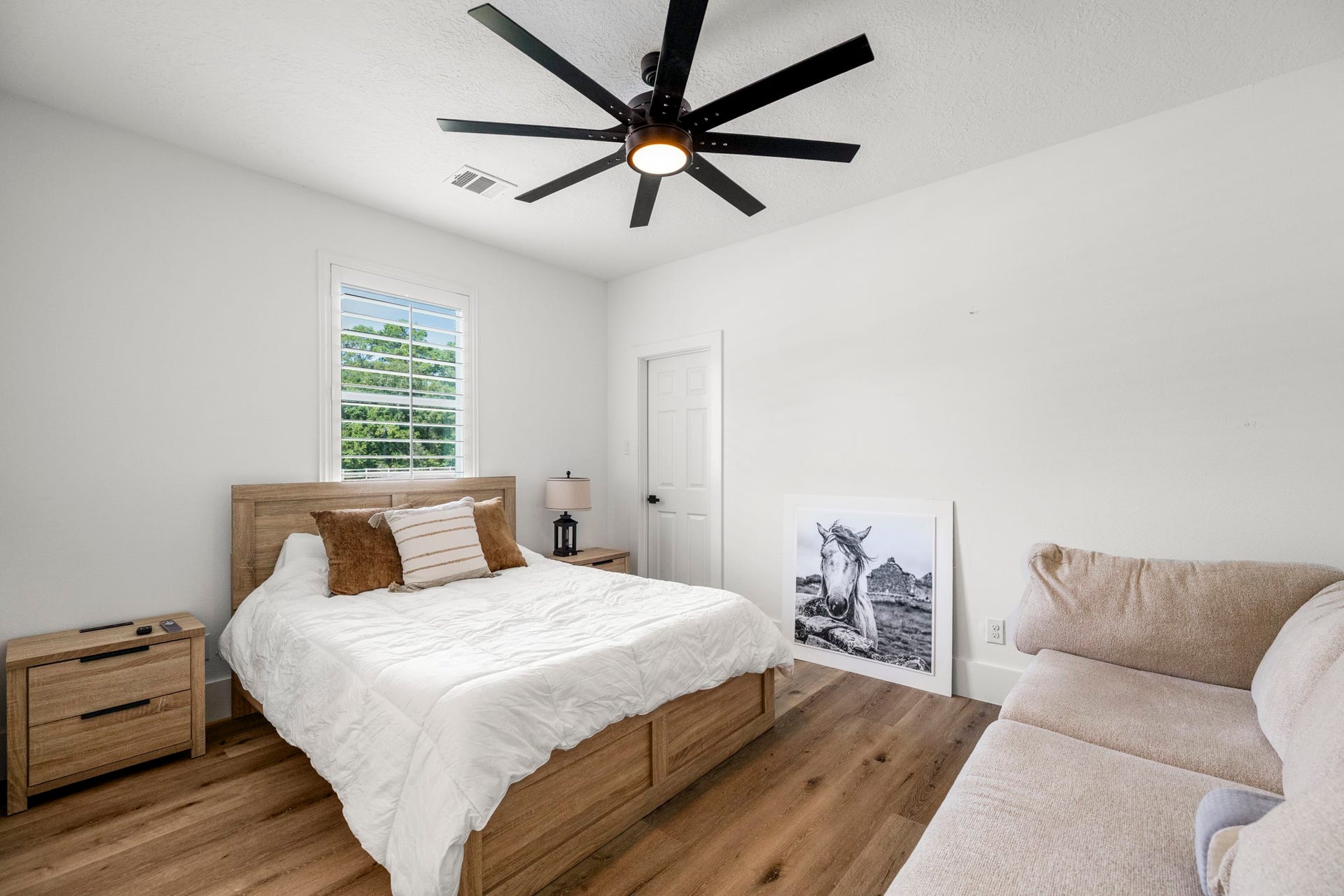 31219 Edgewater Drive, Magnolia, TX 77354 This first-floor bedroom features wood flooring, a ceiling fan and a window overlooking the grounds.