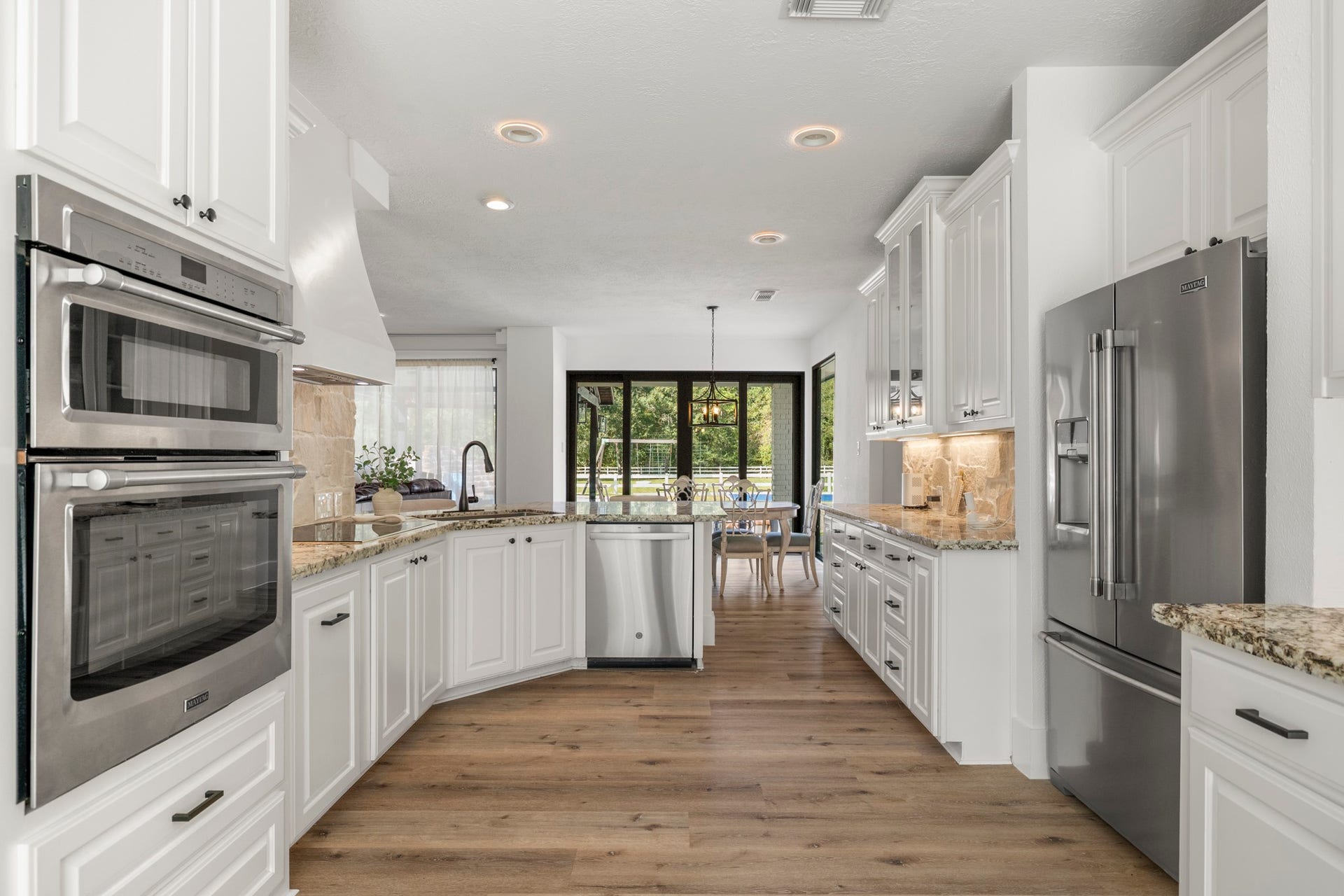 31219 Edgewater Drive, Magnolia, TX 77354 Continue through the kitchen to find extensive cabinetry, generous counter space and built-in ovens.