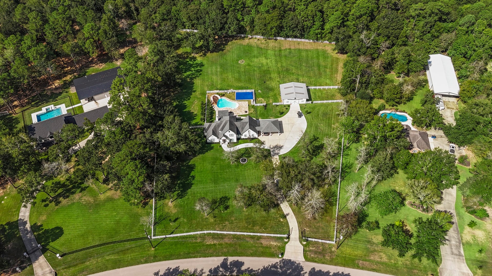 31219 Edgewater Drive, Magnolia, TX 77354 From above, see how the home, pool, sport court, barn and grounds come together.