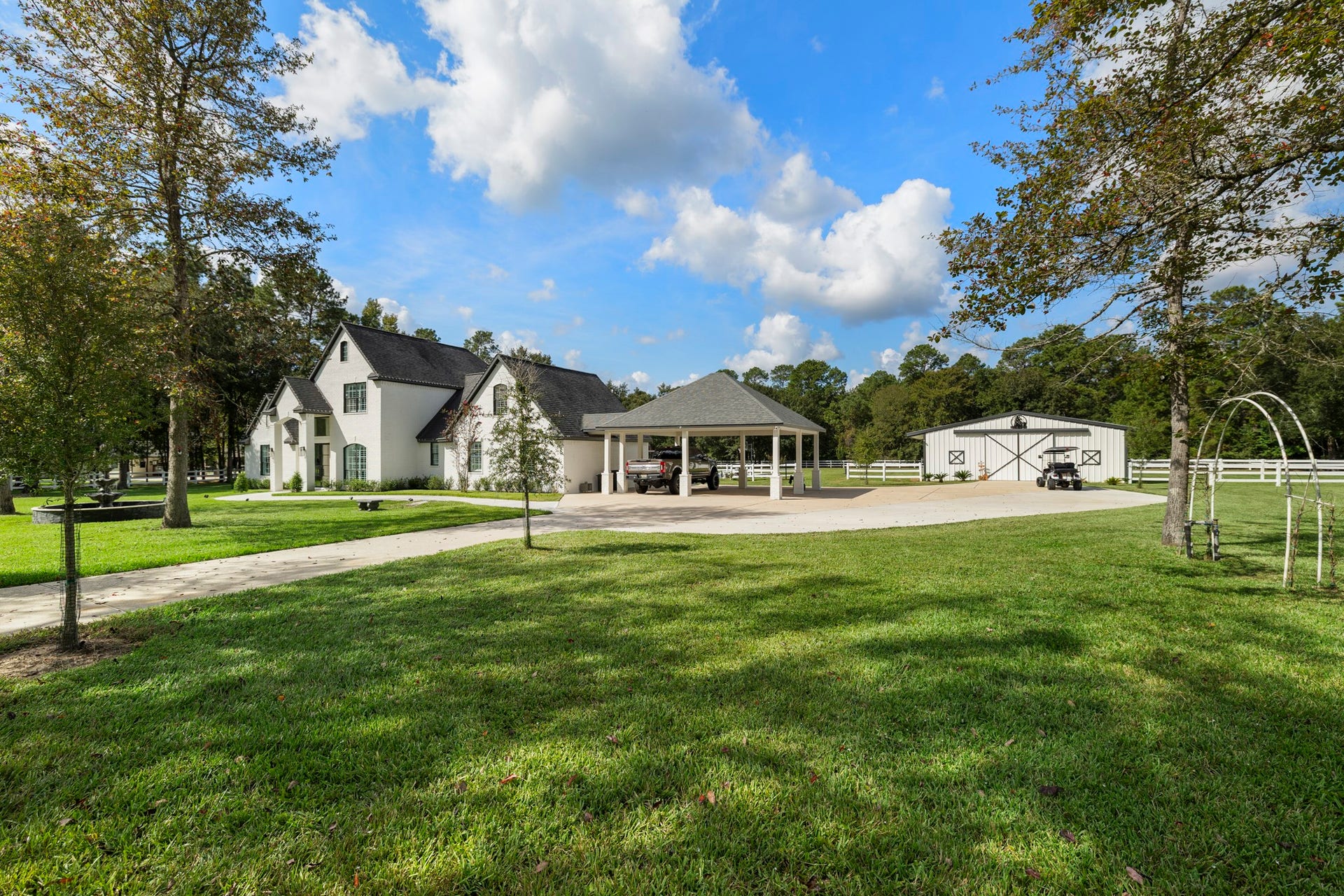 31219 Edgewater Drive, Magnolia, TX 77354 Open lawn and mature trees give the home a peaceful, spacious setting.