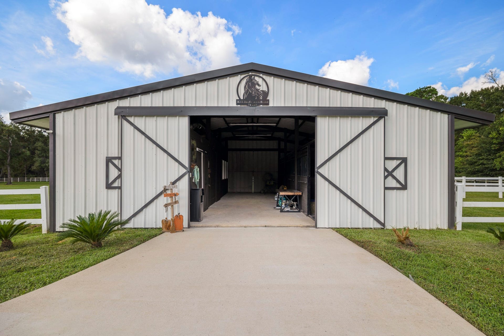 31219 Edgewater Drive, Magnolia, TX 77354 Follow the driveway to the separate barn and its wide entrance.