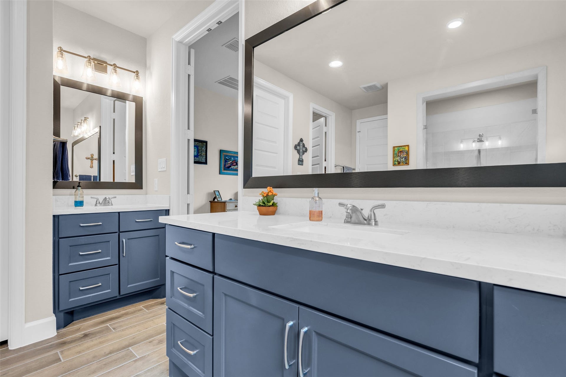 14858 Whistling Duck Lane, Magnolia, TX 77354 Separate, dual vanities and gorgeous blue cabinetry highlight the primary bathroom.