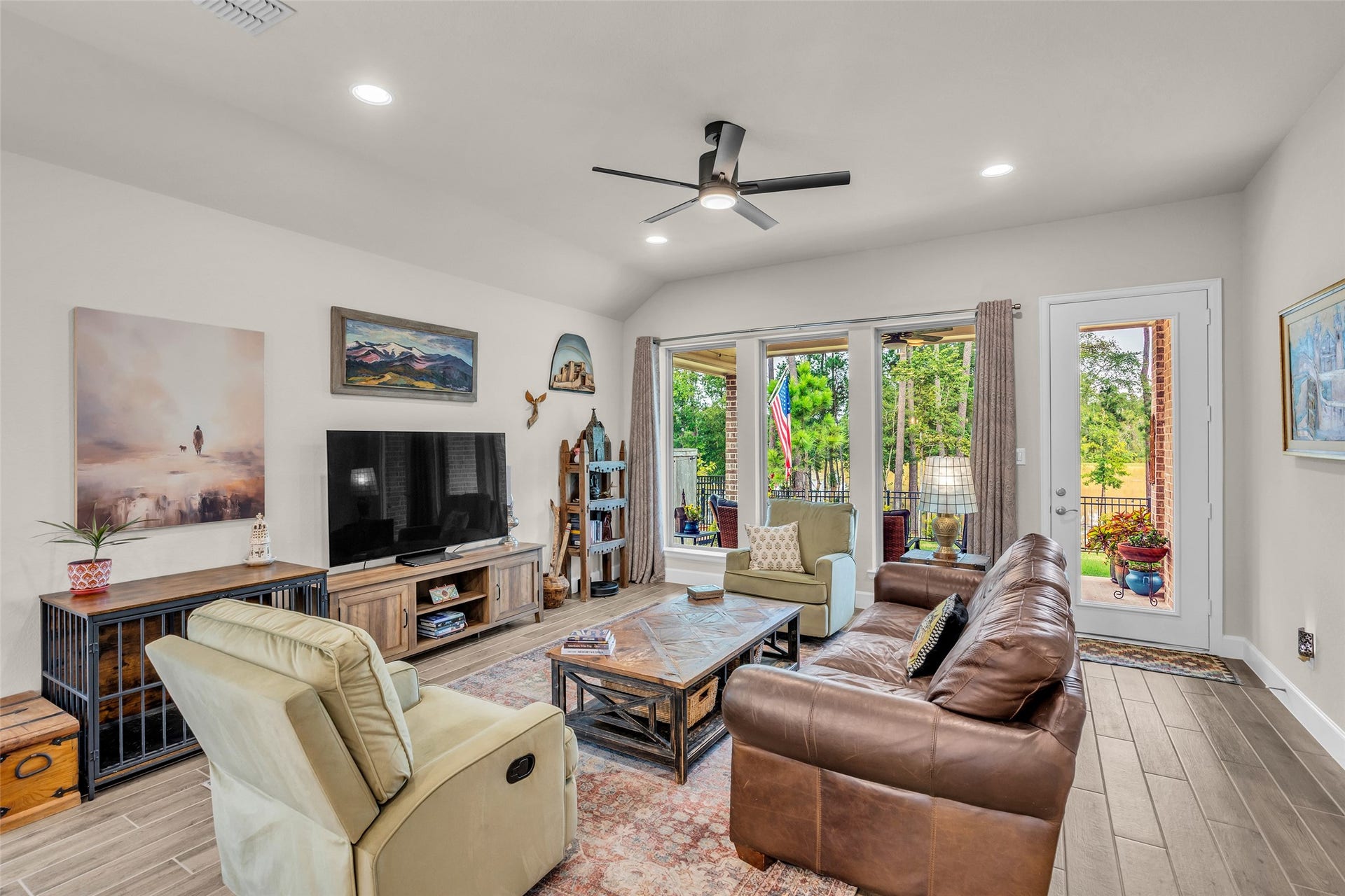 14858 Whistling Duck Lane, Magnolia, TX 77354 The cozy living area offers large windows to experience the natural landscape.