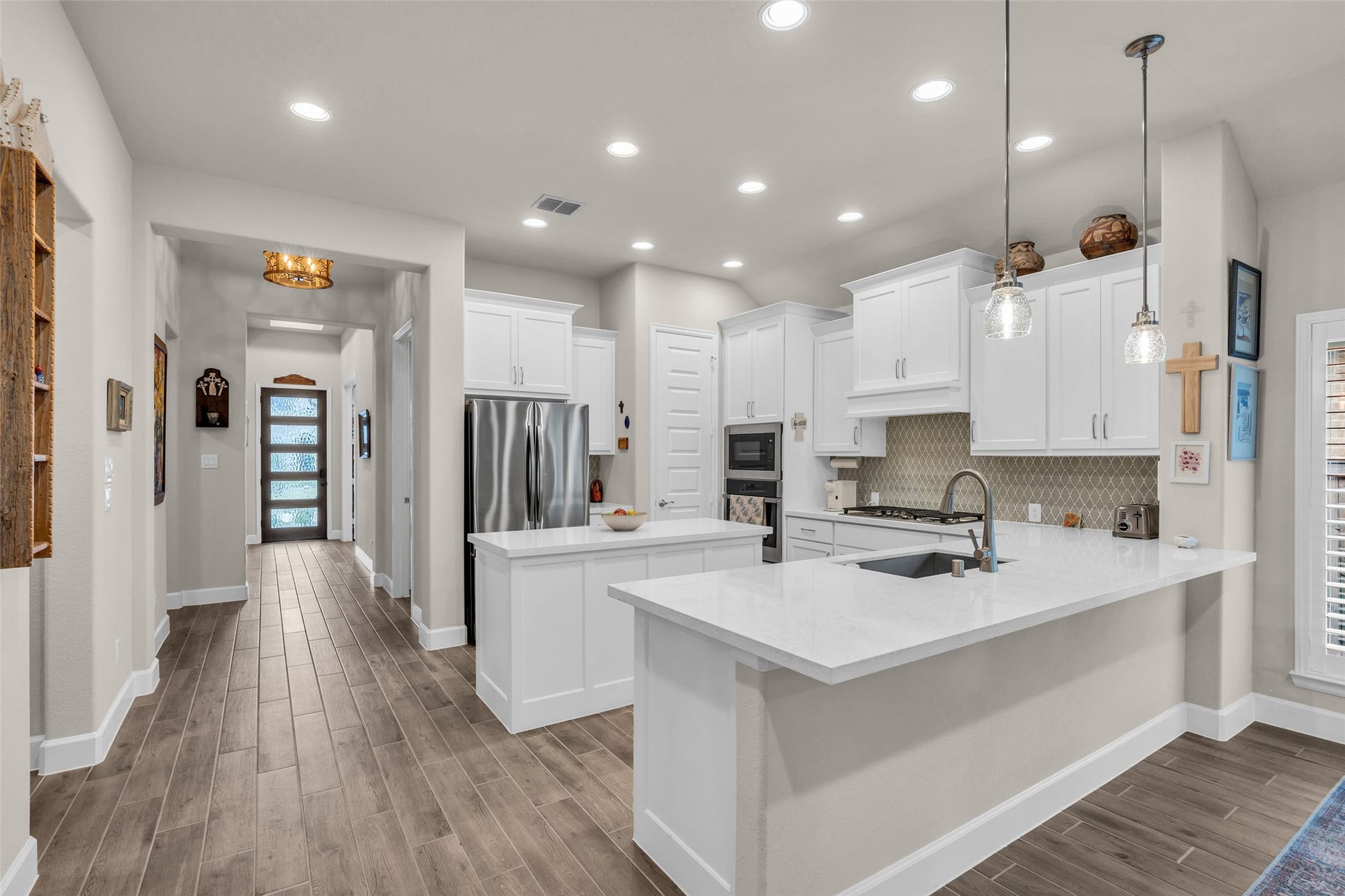 14858 Whistling Duck Lane, Magnolia, TX 77354 Upgrades include 5" baseboards, 9' doors, upgraded lighting and fixtures, and wood-grain tile. (See attachments for details).