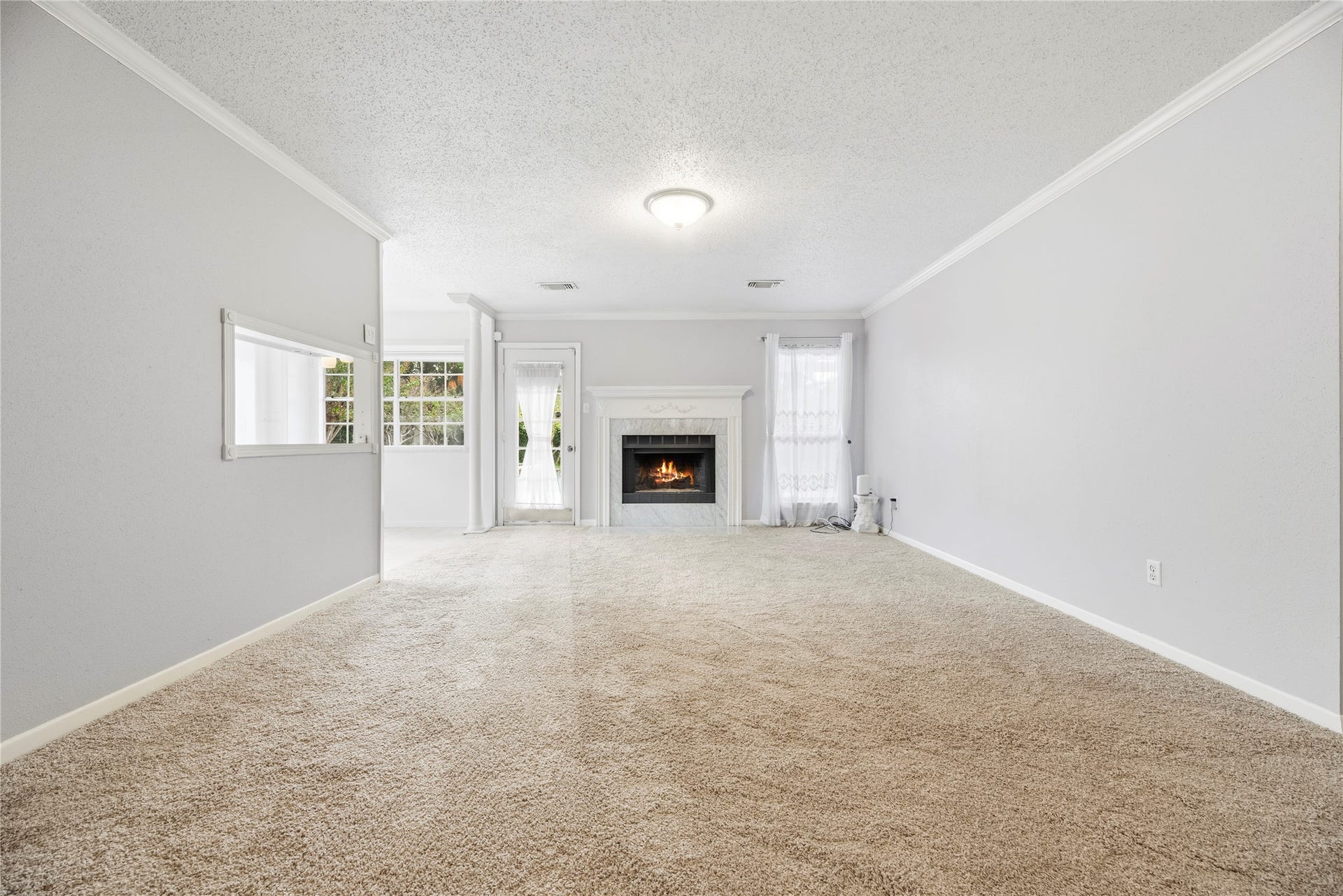 3906 Green Fields Drive, Sugar Land, TX 77479 Spacious living room with fresh paint, brand new carpet, fireplace and large windows for natural light.