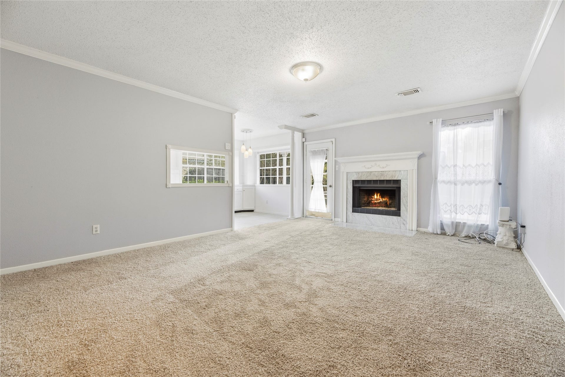 3906 Green Fields Drive, Sugar Land, TX 77479 Spacious living room with fresh paint, brand new carpet, fireplace and large windows for natural light.