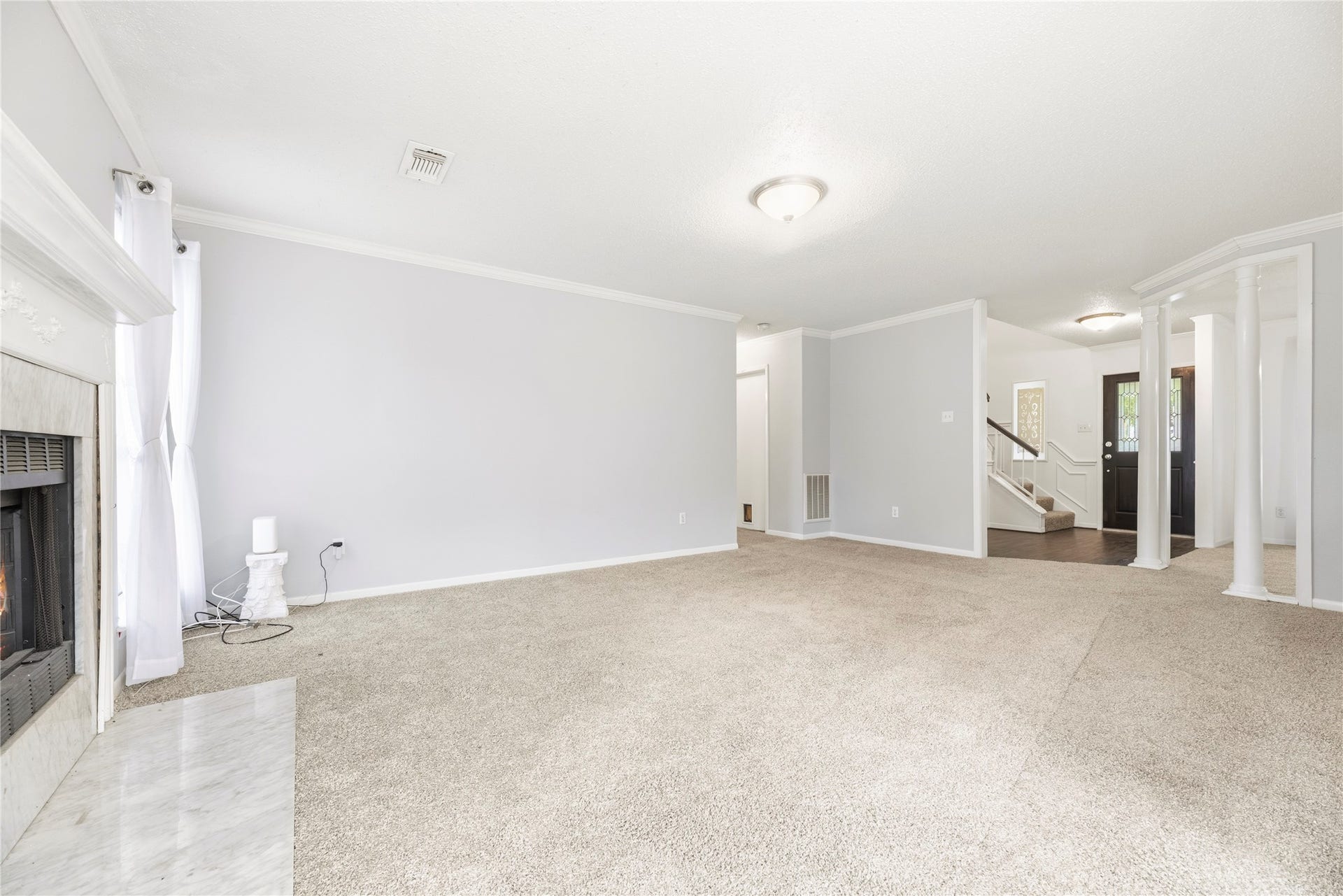 3906 Green Fields Drive, Sugar Land, TX 77479 Spacious living room with fresh paint, brand new carpet, fireplace and large windows for natural light.
