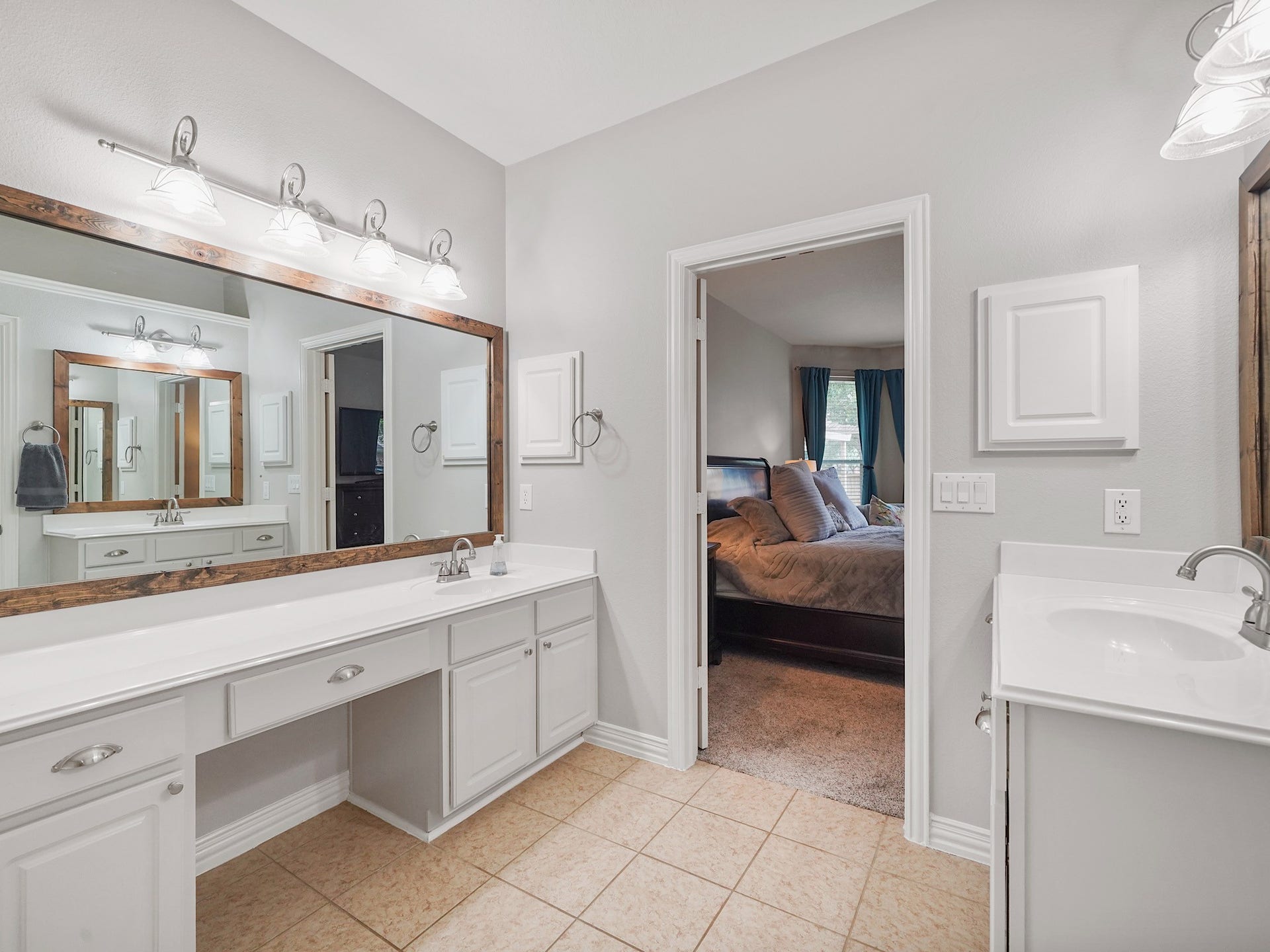 26214 Seminole Hill Lane, Katy, TX 77494 Dual sinks, a dedicated vanity area, and abundant cabinetry provide plenty of room for busy mornings.