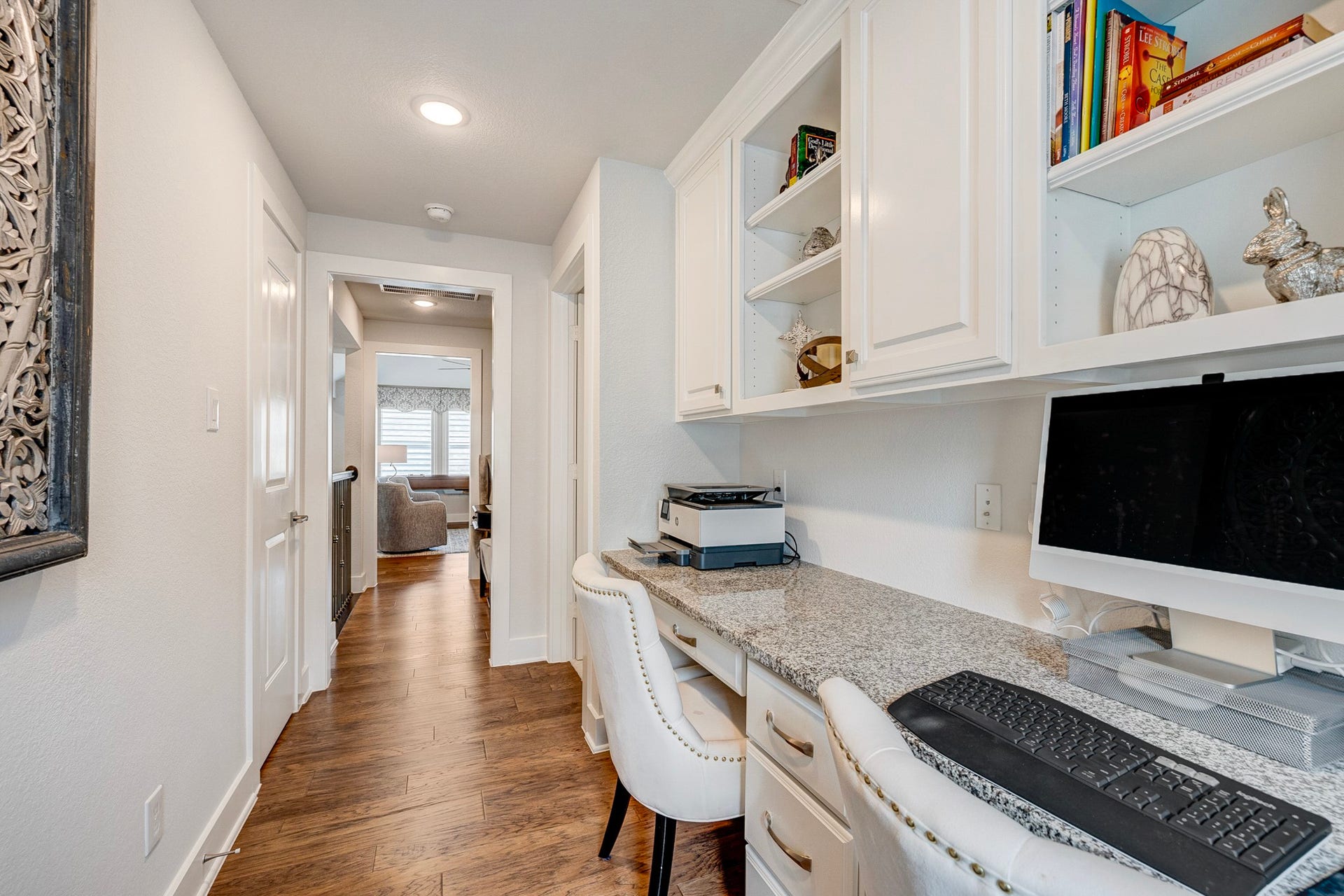 121 Sugar Pine Court, Montgomery, TX 77316 Beautiful wood flooring throughout, featuring a functional desk area, custom cabinetry, and built-in shelving for maximum storage efficiency.