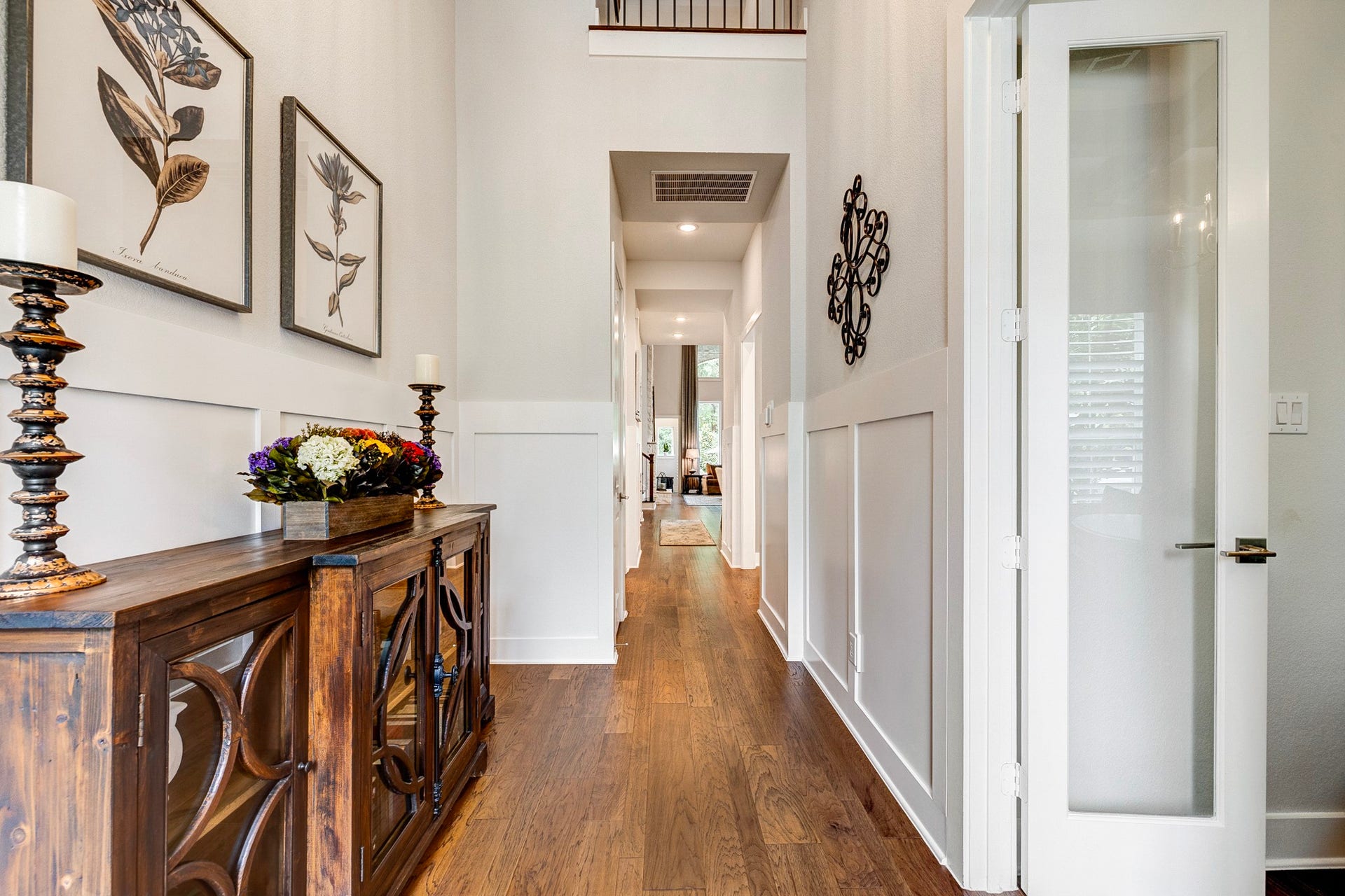 121 Sugar Pine Court, Montgomery, TX 77316 Stunning two-story entryway featuring elegant upgraded wainscoting and architectural detailing.