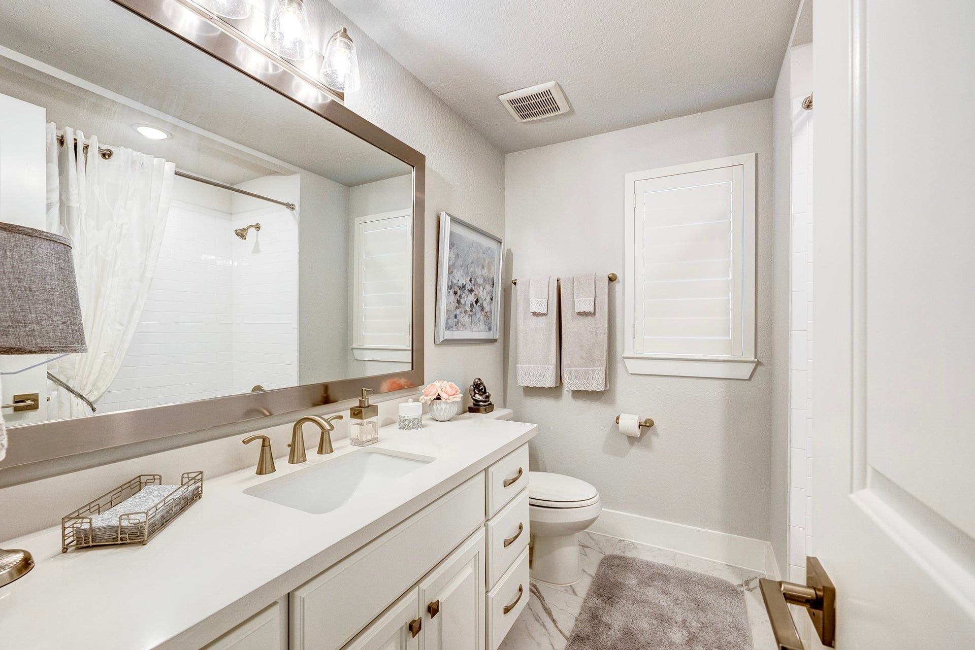 121 Sugar Pine Court, Montgomery, TX 77316 Upgraded bathroom featuring a custom-framed mirror and window shutters that provide both privacy and soft, natural light.