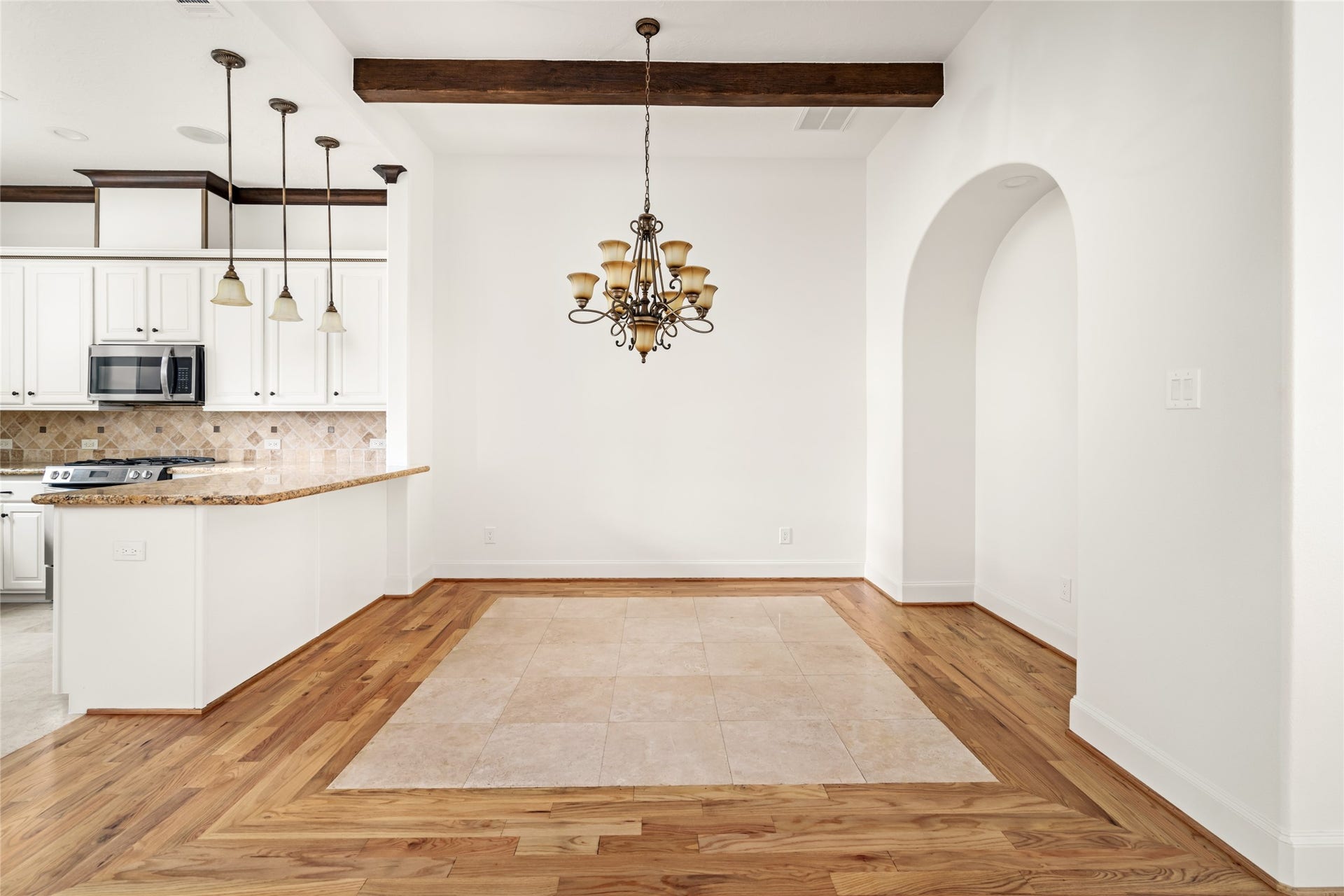 5218 Feagan Street, #D, Houston, TX 77007 Dining room with exposed wood ceiling beams and a decorative chandelier.
