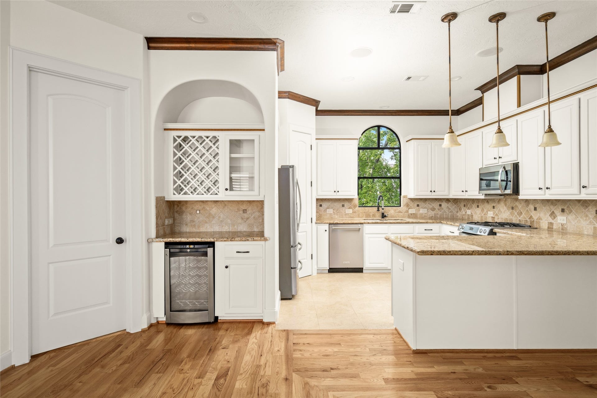 5218 Feagan Street, #D, Houston, TX 77007 View of the built-in wine bar and kitchen from the living room.