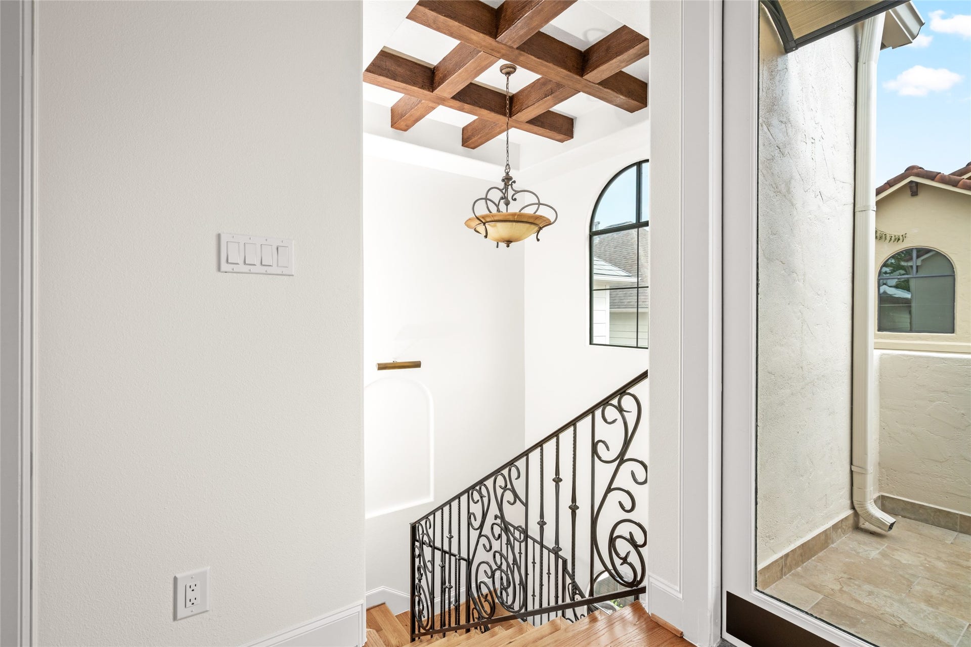 5218 Feagan Street, #D, Houston, TX 77007 View from the third floor hallway featuring wood beam accent with chandelier.