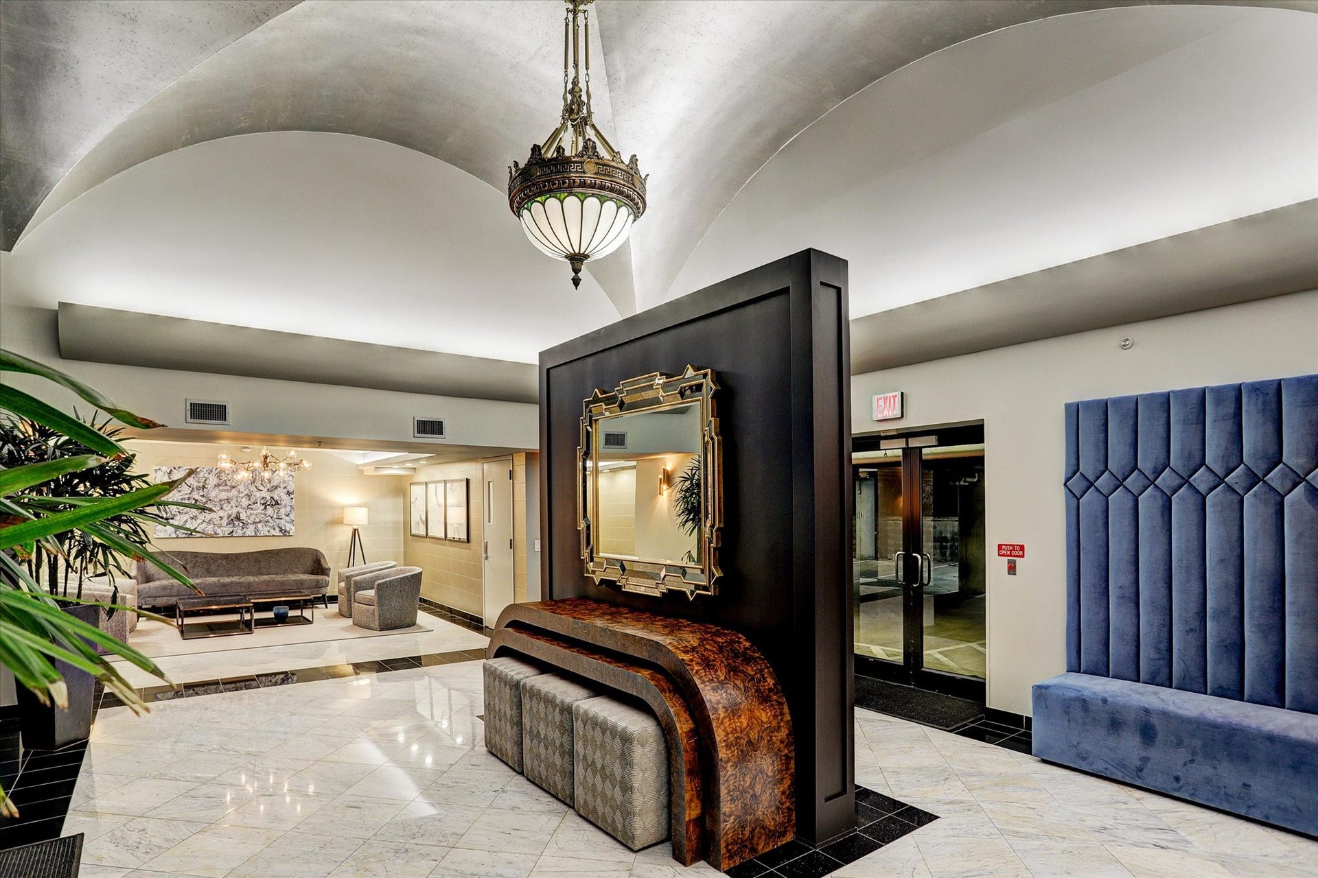 An inviting common area features comfortable seating, decorative finishes, and elegant architectural details. The thoughtfully furnished space reflects the building's classic design and welcoming atmosphere.