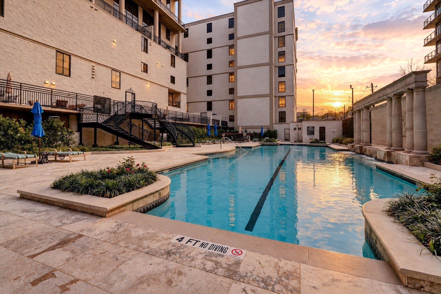 The Renoir features a private community swimming pool surrounded by landscaped grounds and an inviting poolside terrace. Residents enjoy this amenity as part of the building's shared residential offerings.