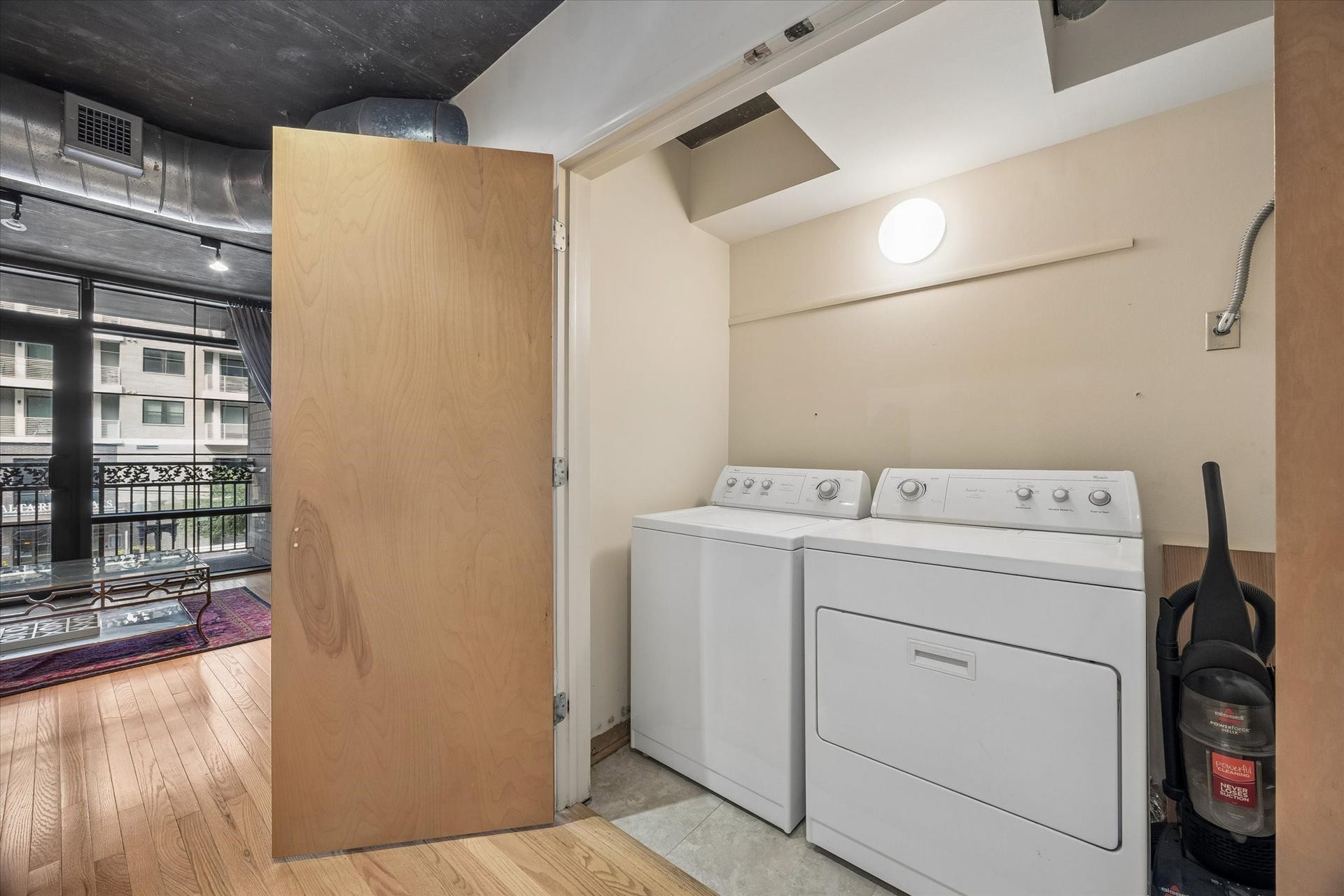 A dedicated laundry area includes a full-size washer and dryer conveniently located within the residence. Additional space provides practical functionality while keeping laundry separate from the main living areas.