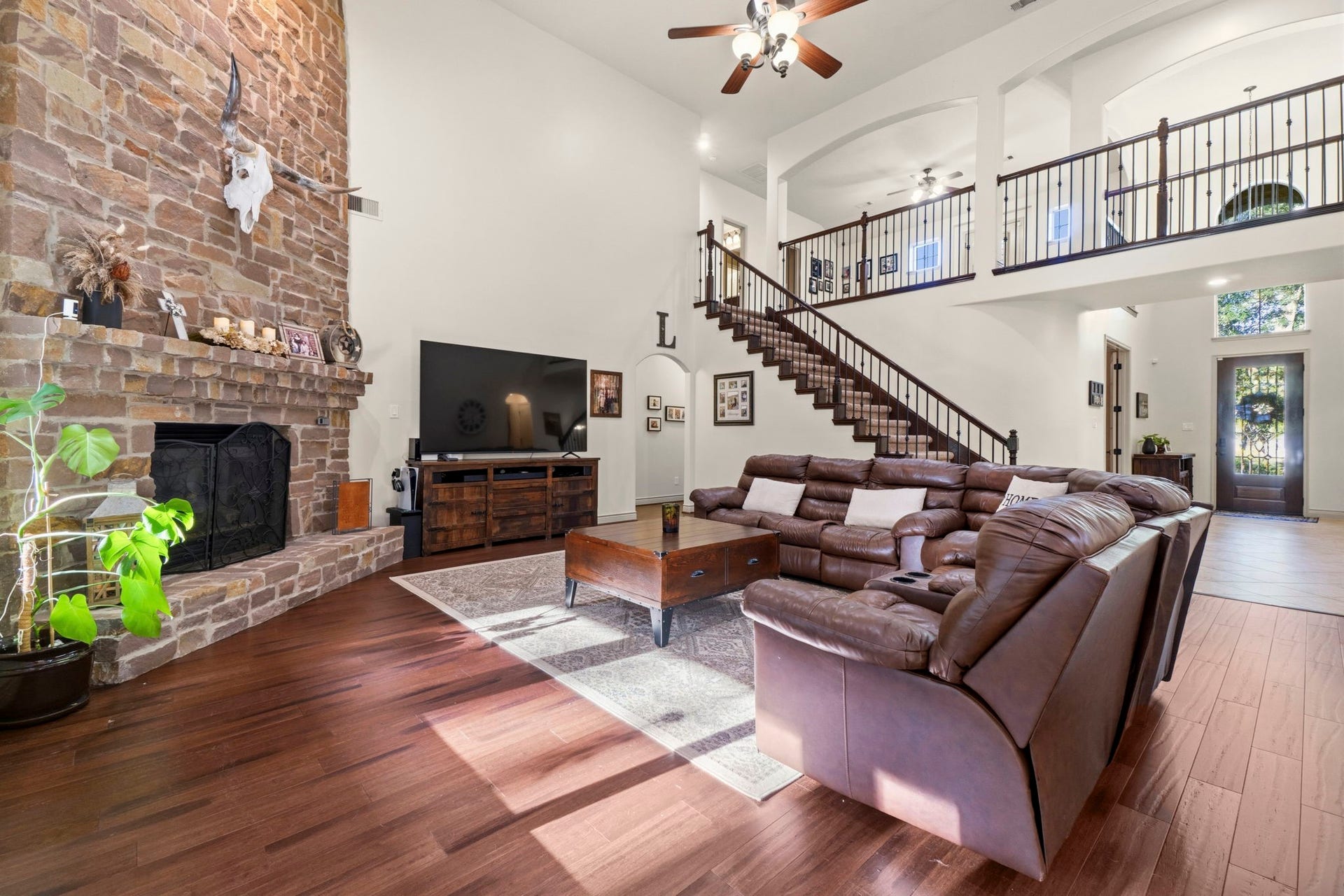 11612 Princess Ann Court, Montgomery, TX 77316 Soaring ceilings and a dramatic floor-to-ceiling stone fireplace.