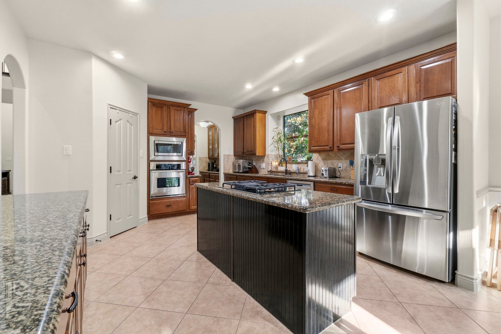 11612 Princess Ann Court, Montgomery, TX 77316 Granite countertops, stainless appliances, gas cooktop, and oversized island.