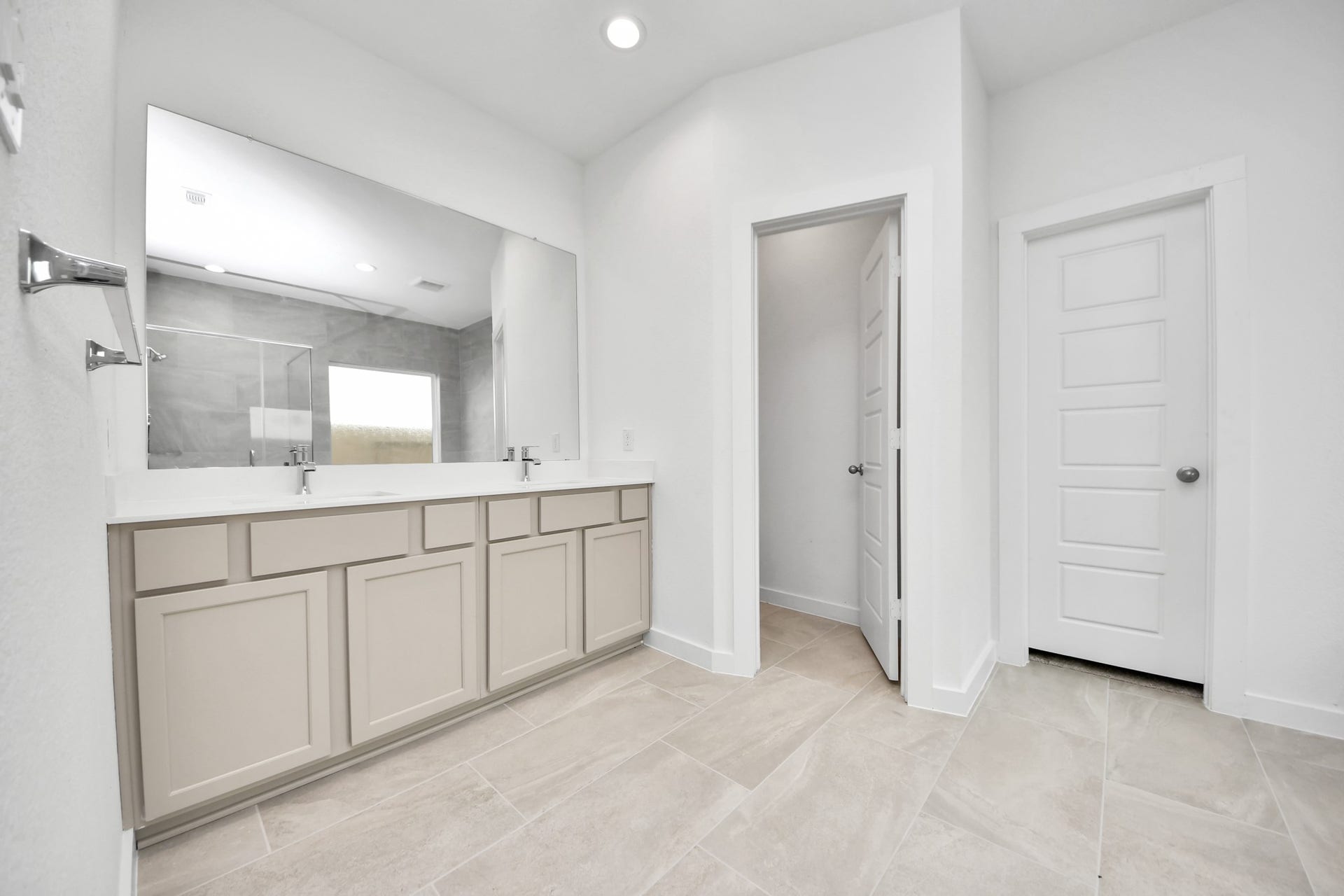 2114 Della Lakes Court, Fresno, TX 77545 Elevate your daily routine at the elegant vanity, now equipped with double sinks, light countertops, modern hardware, and beautiful recessed lights. Sample photo of completed home with similar floor plan. Actual colors and selections may vary.