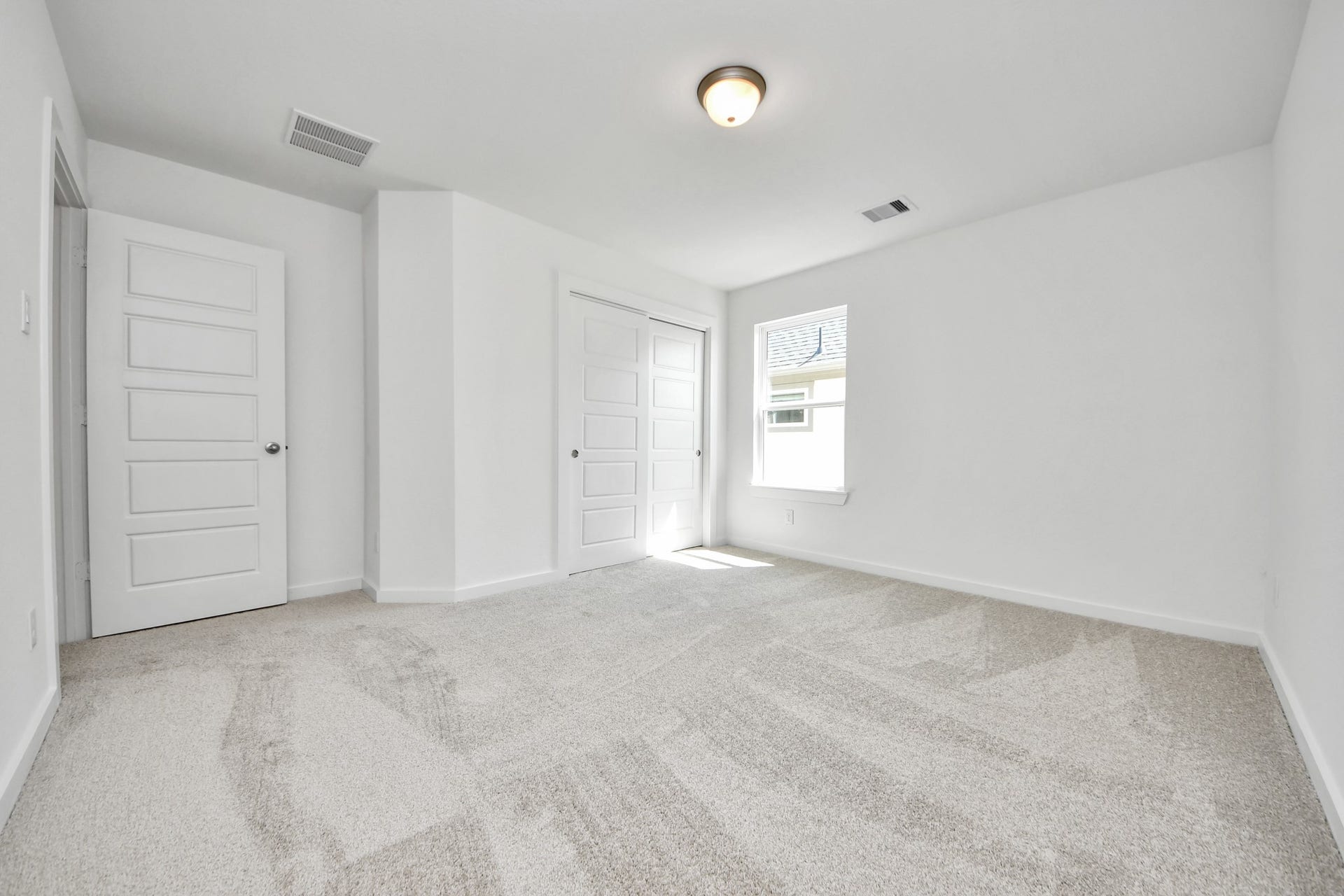 2114 Della Lakes Court, Fresno, TX 77545 Generously sized secondary bedrooms featuring spacious closets, soft and inviting carpeting underfoot, large windows allowing plenty of natural light, and the added touch of privacy blinds for your personal retreat. Sample photo of completed home with similar floor plan. Actual colors and selections may vary.