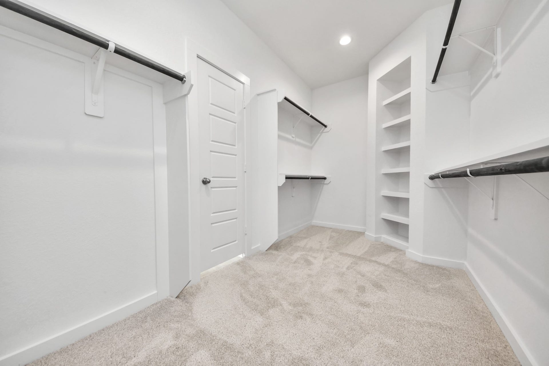 2114 Della Lakes Court, Fresno, TX 77545 Walk-in closet that epitomizes luxury and practicality. This generously sized space features built-in shelving, offering abundant room for impeccable organization. High ceilings and recessed lighting create a bright and welcoming ambiance. Sample photo of completed home with similar floor plan. Actual colors and selections may vary.
