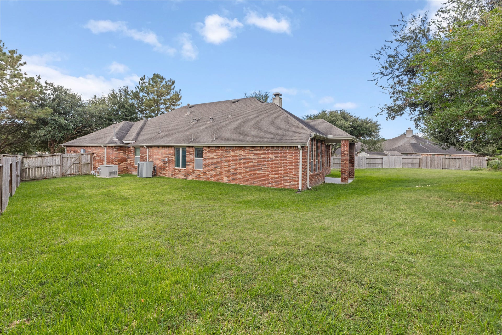 Charming brick home with a spacious backyard, perfect for outdoor activities and relaxation.
