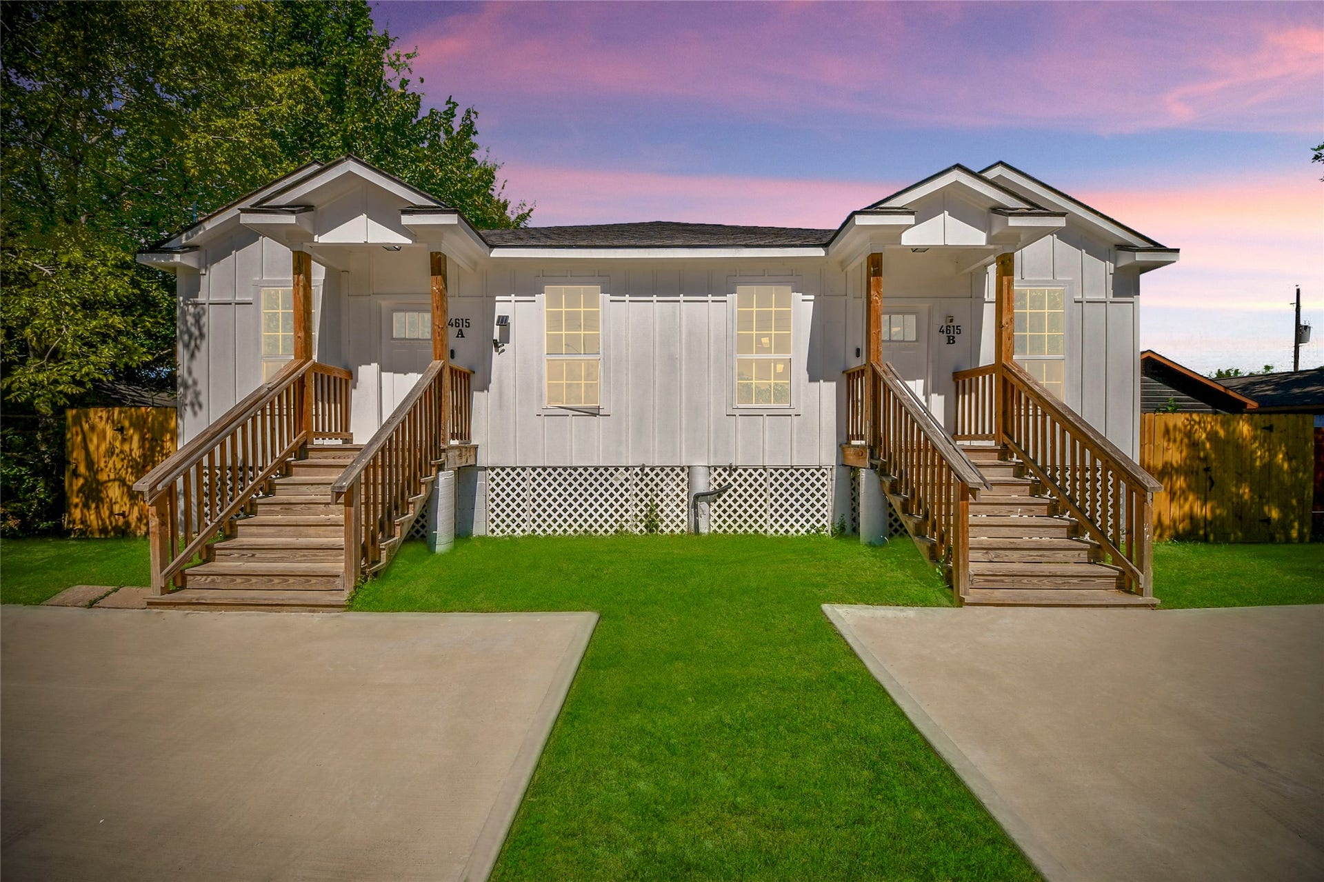 4615 Collingsworth Street, #AB, Houston, TX 77026 Charming duplex with a fresh, modern exterior, featuring twin entryways and inviting wooden porches.