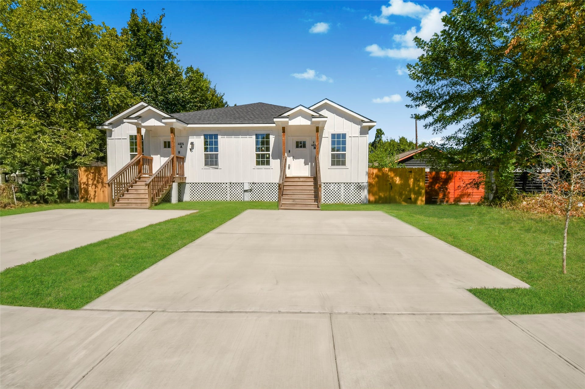 4615 Collingsworth Street, #AB, Houston, TX 77026 Charming duplex with a modern exterior, featuring two separate entrances, spacious driveways, and surrounded by lush greenery for added privacy.