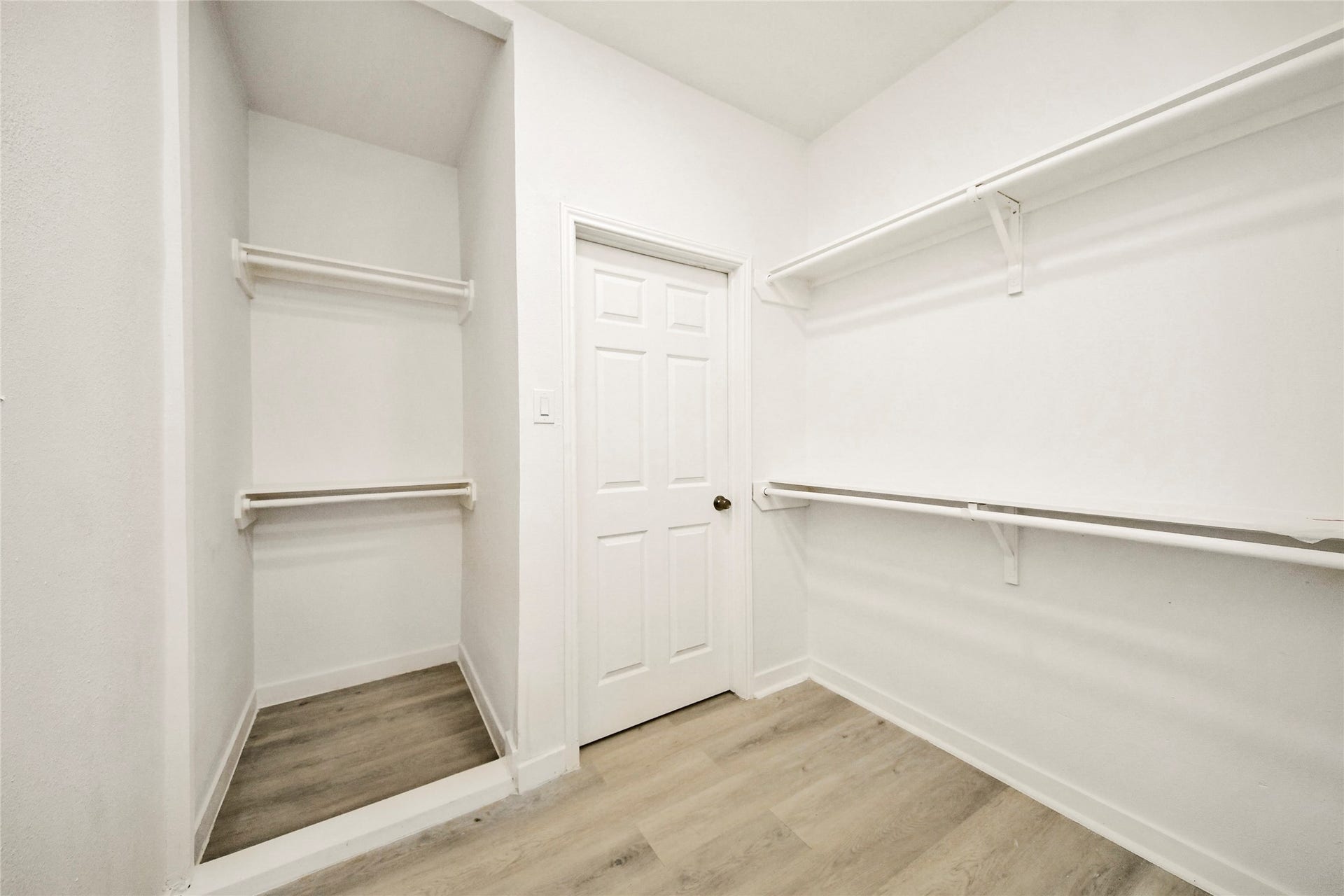 4615 Collingsworth Street, #AB, Houston, TX 77026 Spacious walk-in closet featuring ample shelving and hanging space, complemented by light wood flooring and a clean, bright finish.