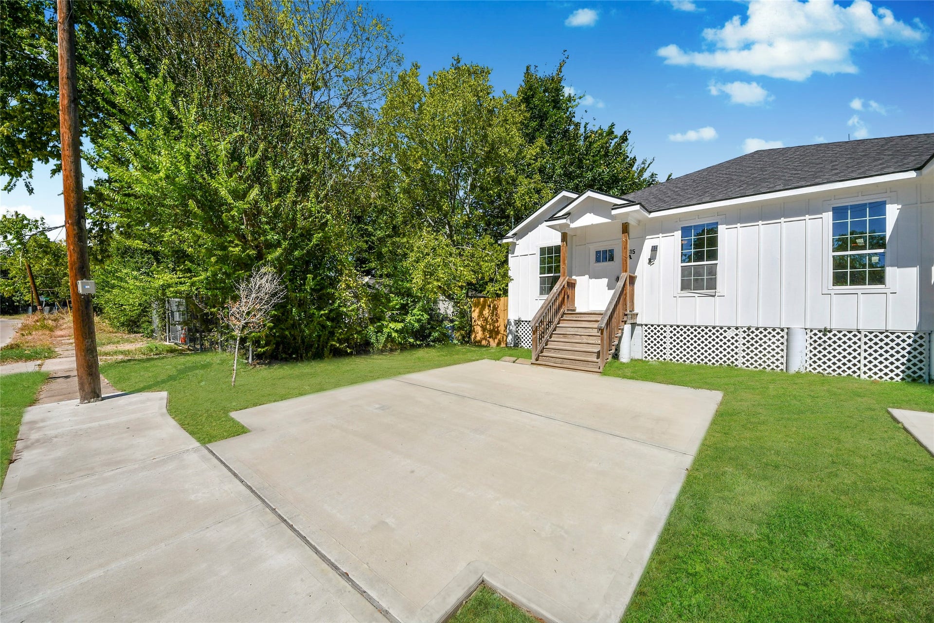 4615 Collingsworth Street, #AB, Houston, TX 77026 Charming home with a modern facade, featuring a welcoming front porch and surrounded by lush greenery. Ideal for those seeking a blend of comfort and style.