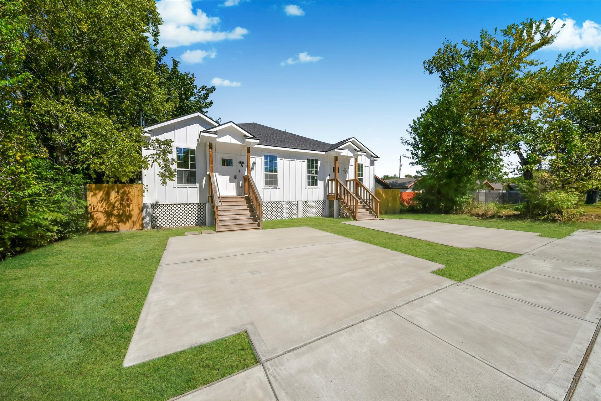 4615 Collingsworth Street, #AB, Houston, TX 77026 Charming white house with a welcoming front porch, nestled amidst lush greenery, features a spacious driveway and inviting curb appeal.