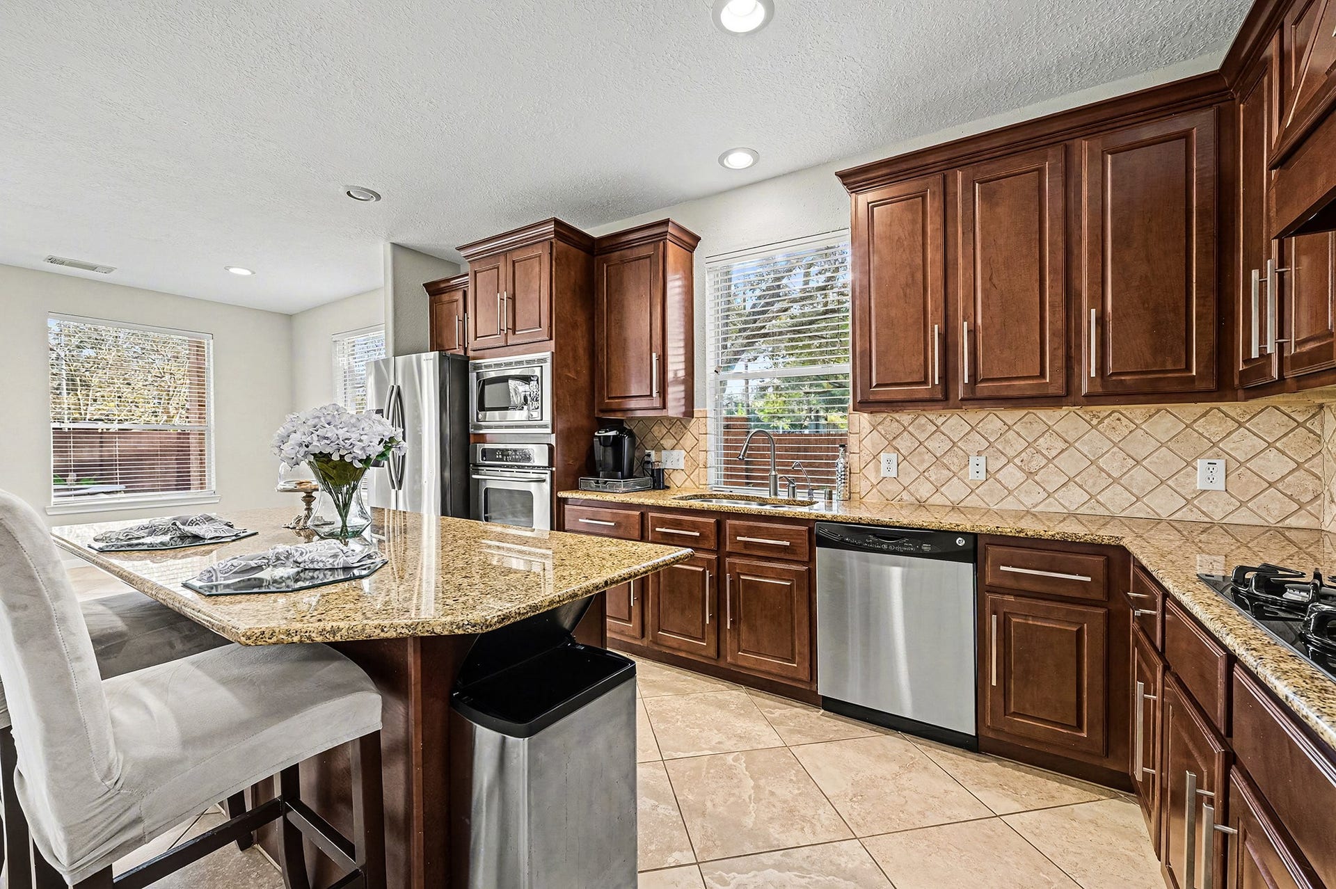 Another great view of spacious kitchen with granite, seated island, ample counter space and so much storage.