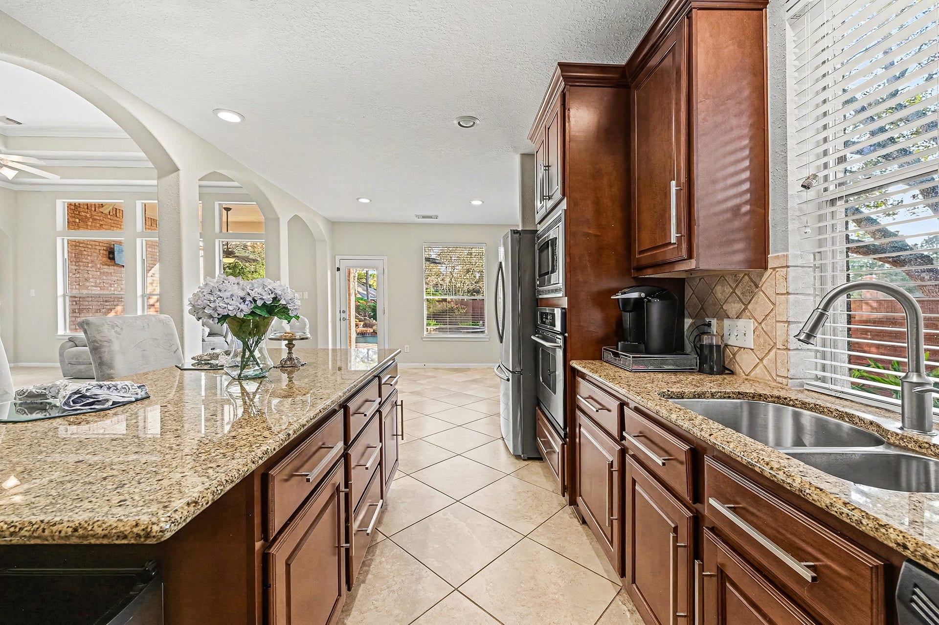 This is another great view of kitchen showcasing all the kentwood soft closing closing cabinets with stainless pulls, diagonally laid tile and backsplash.