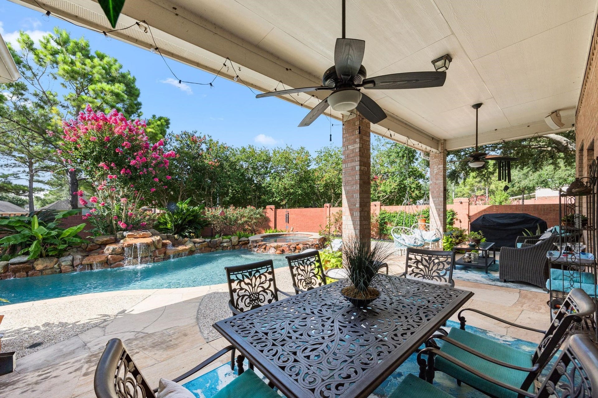 Welcome to your private retreat. This inviting salt water heated pool/spa with 7 rock waterfalls, flagstone patio & decking surrounded by lush flowering landscaping with surround sound and HOA brick privacy fence is a must see.
BARBEQUE PIT AND AQUA DOUBLE COVERED LOUNGER (stays with home).