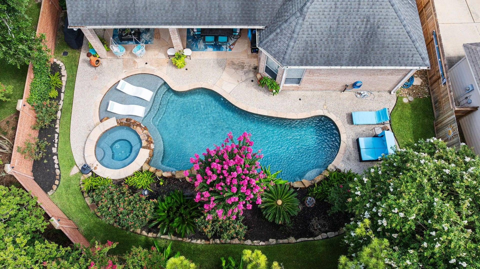 Home Sweet Home! This is a beautiful aerial view of the outdoor paradise with pool,spa, sun tanning ledge with tropical landscaping, mosquito mister, tranquil setting for relaxation. No backdoor neighbors.