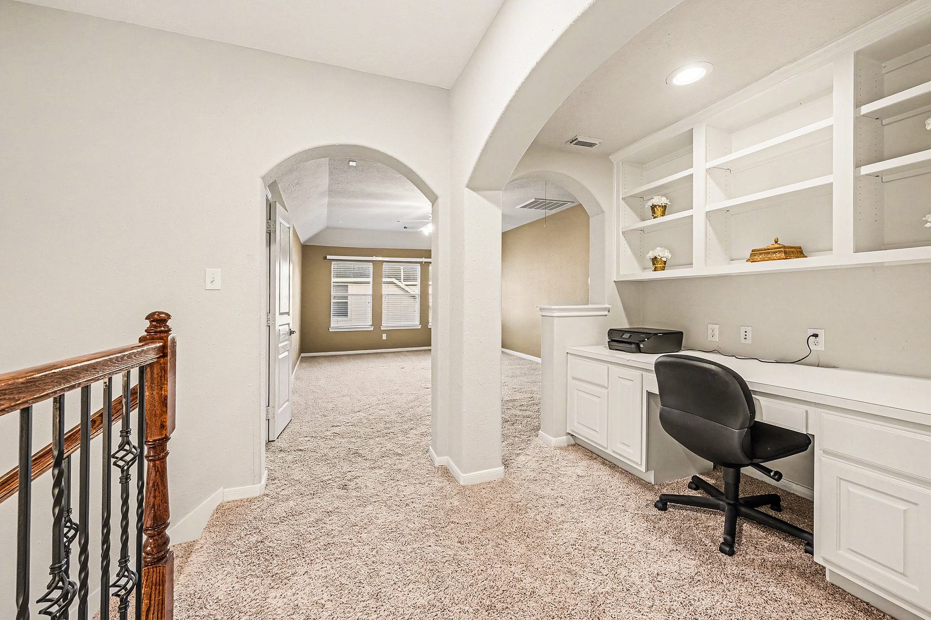 Upstairs nook with arches for office spaace, place for the kids to study with ample shelfing and storage which opens to gameroom.