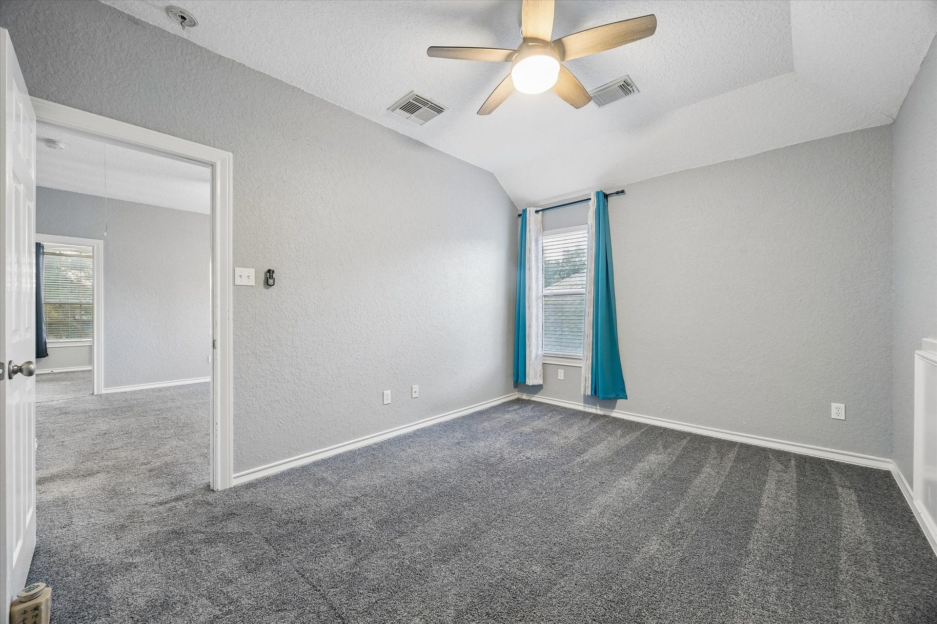 5115 Redleaf Forest Lane, Katy, TX 77494 One of two generously sized upstairs secondary bedrooms, both featuring spacious layouts and walk-in closets with ample storage.