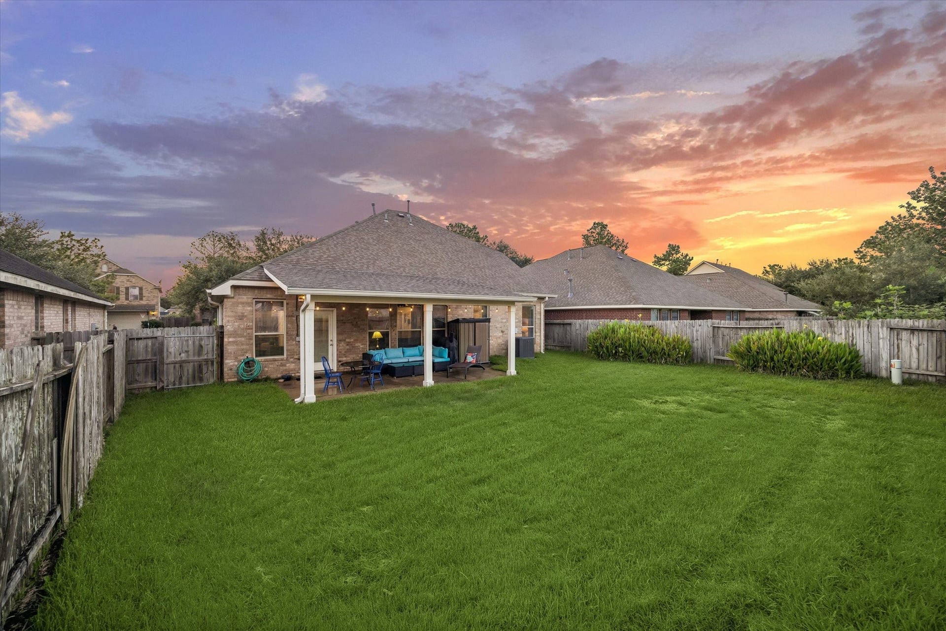 5115 Redleaf Forest Lane, Katy, TX 77494 The generous backyard features a wide expanse of lush green lawn with plenty of room to play, garden, or create your own outdoor retreat. The oversized covered patio extends the home's living space outdoors, offering a great setting to enjoy the peaceful backyard views.
