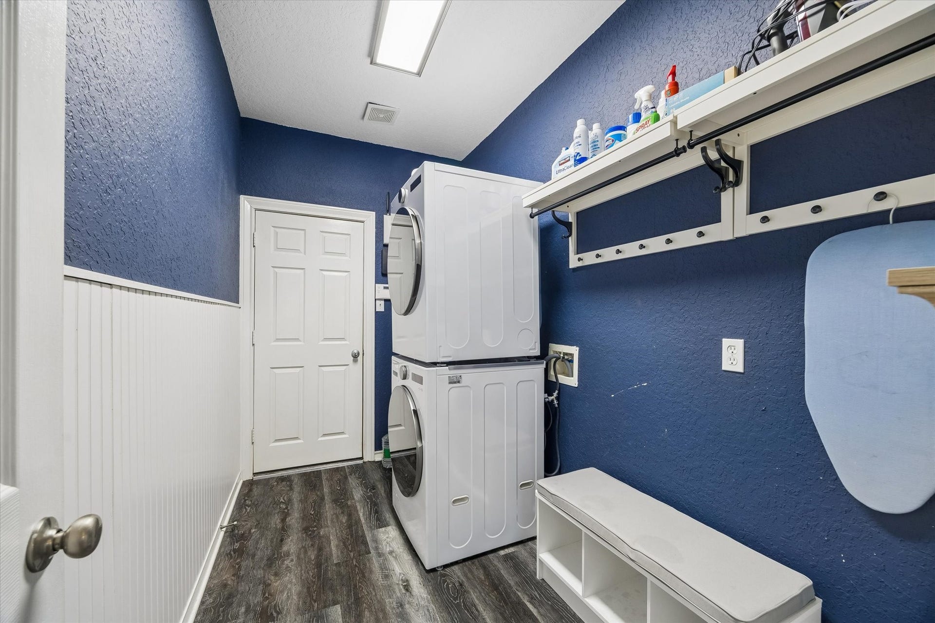 5115 Redleaf Forest Lane, Katy, TX 77494 The spacious combination laundry and mudroom offers a functional layout with built-in bench seating, shelving, and plenty of room for laundry and everyday storage.