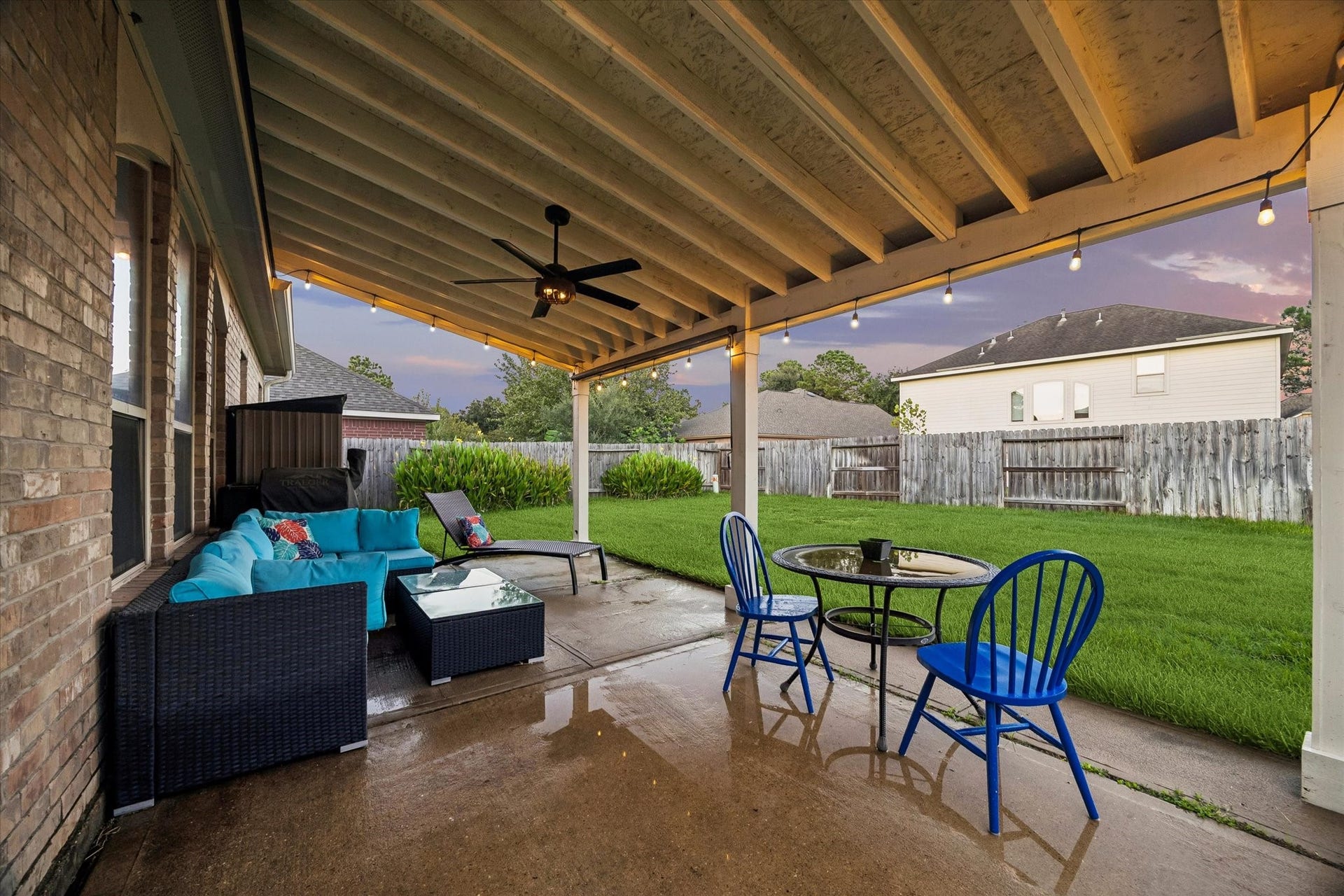 5115 Redleaf Forest Lane, Katy, TX 77494 The expansive covered patio offers plenty of space for outdoor dining and entertaining, complete with ceiling fan and bistro lighting. The large, fully fenced backyard provides ample room for outdoor activities, pets, or a future pool.