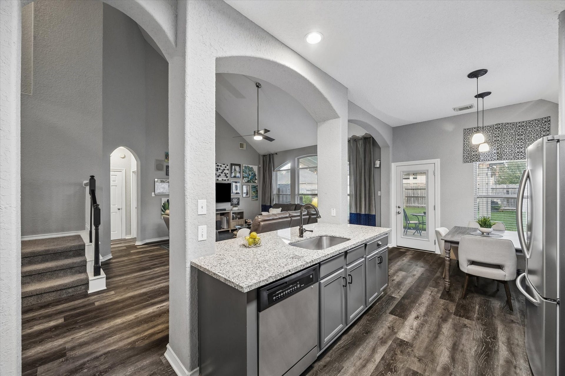 5115 Redleaf Forest Lane, Katy, TX 77494 The beautifully updated kitchen features sleek stainless steel appliances, elegant granite countertops, a stylish backsplash, freshly painted cabinetry, and updated hardware, creating a welcoming space that perfectly blends style and functionality.